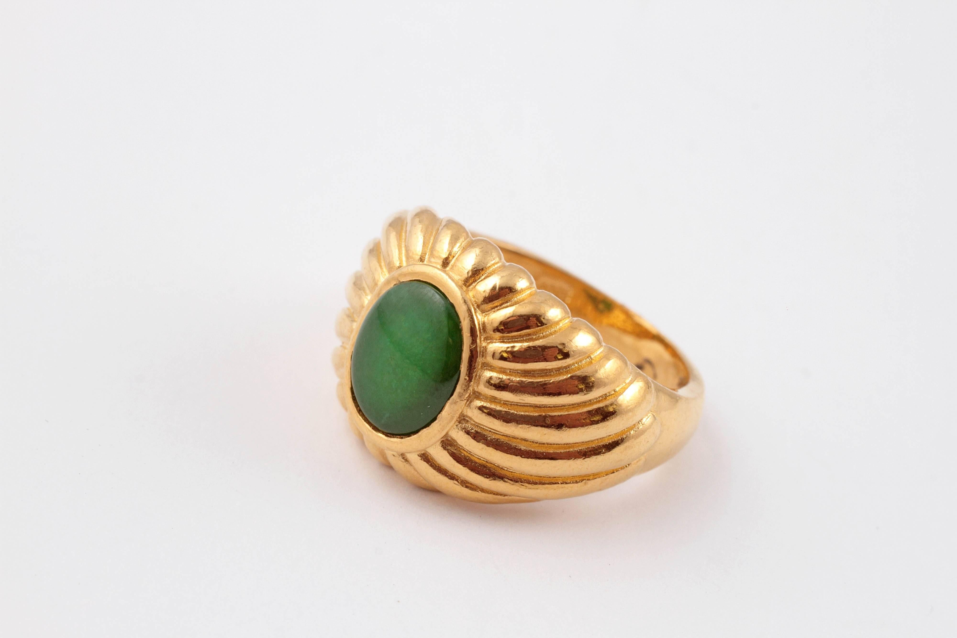 Tapering swirling style mounting, in 22 Karat yellow gold, centered with an oval-shaped, Jade.  Size 9.