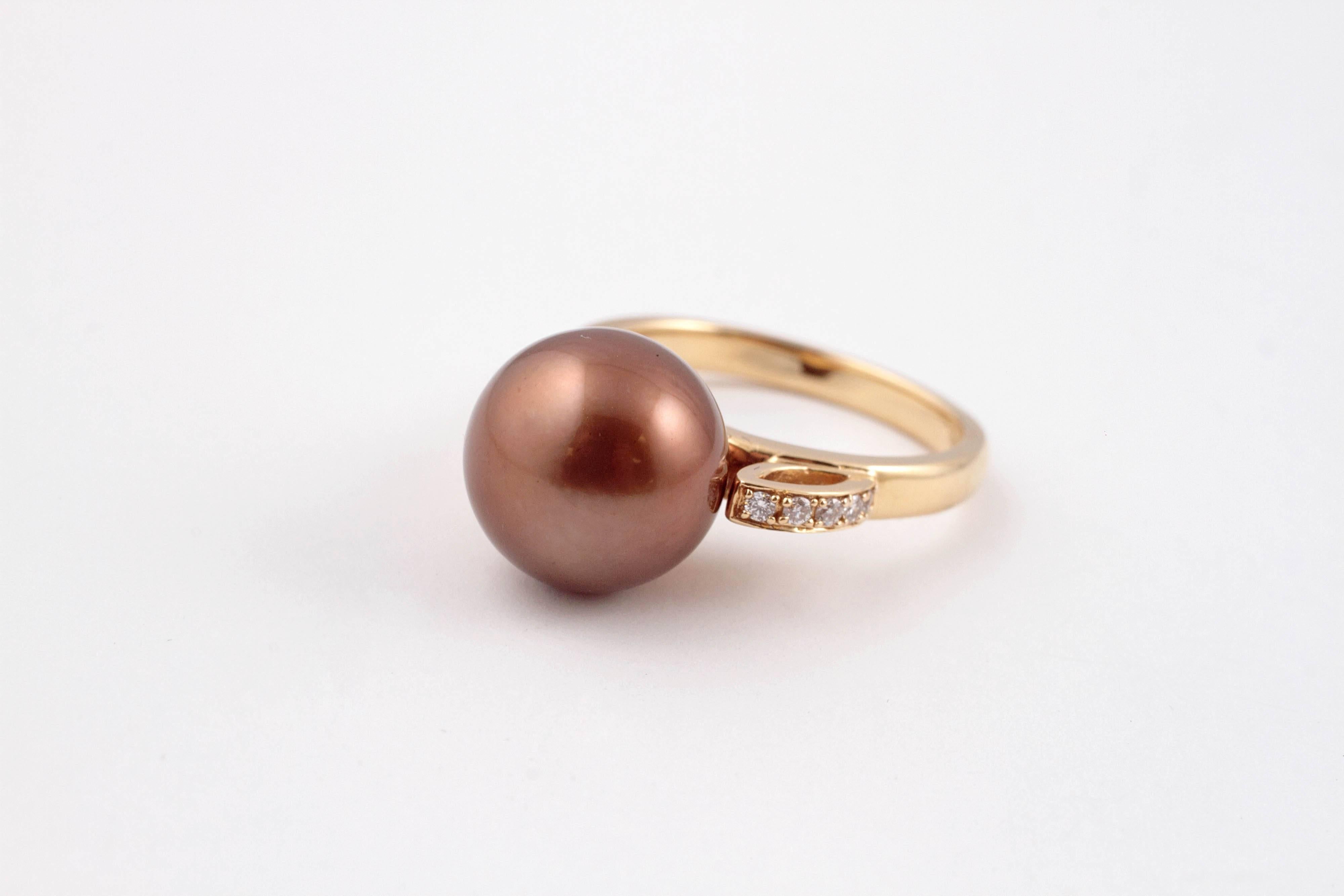 Large 11.60 mm bronze pearl accented with diamonds in an 18 karat gold mounting.  Size 7.