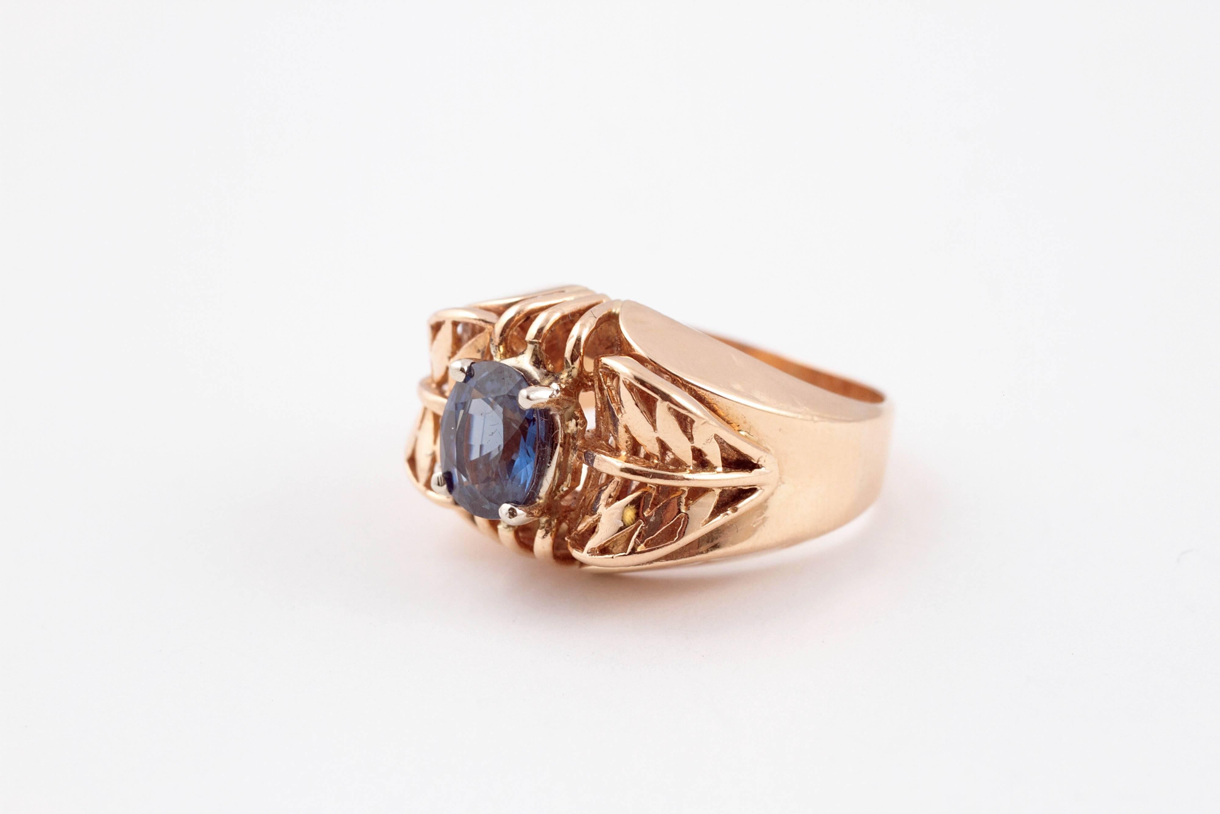 1.35 carat blue sapphire set in intricate 14 karat gold mounting.  Size 7.