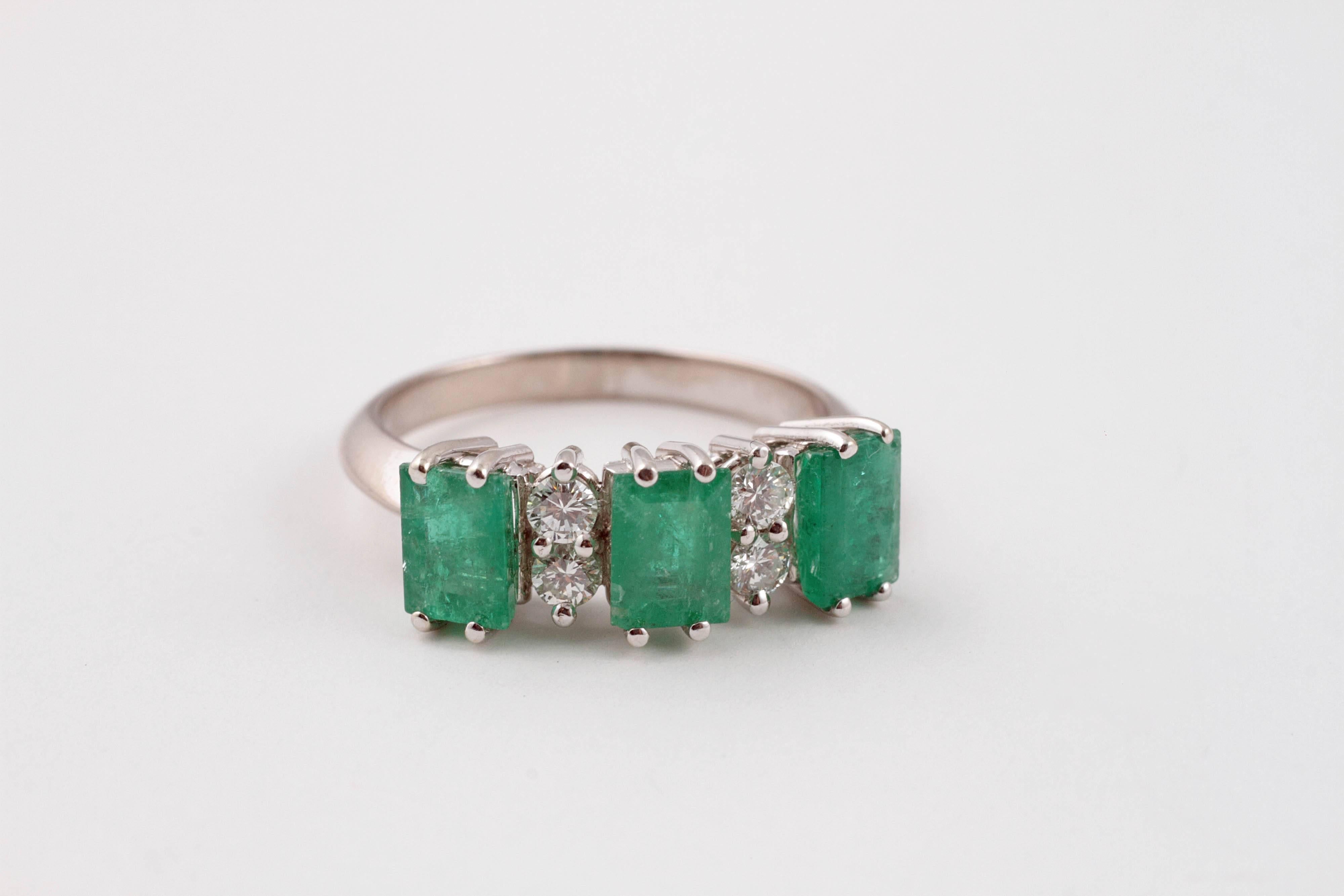 Vibrant 1.50 carats of emeralds accented with .20 carats of diamonds set in 18 karat white gold.  Size 7.25.