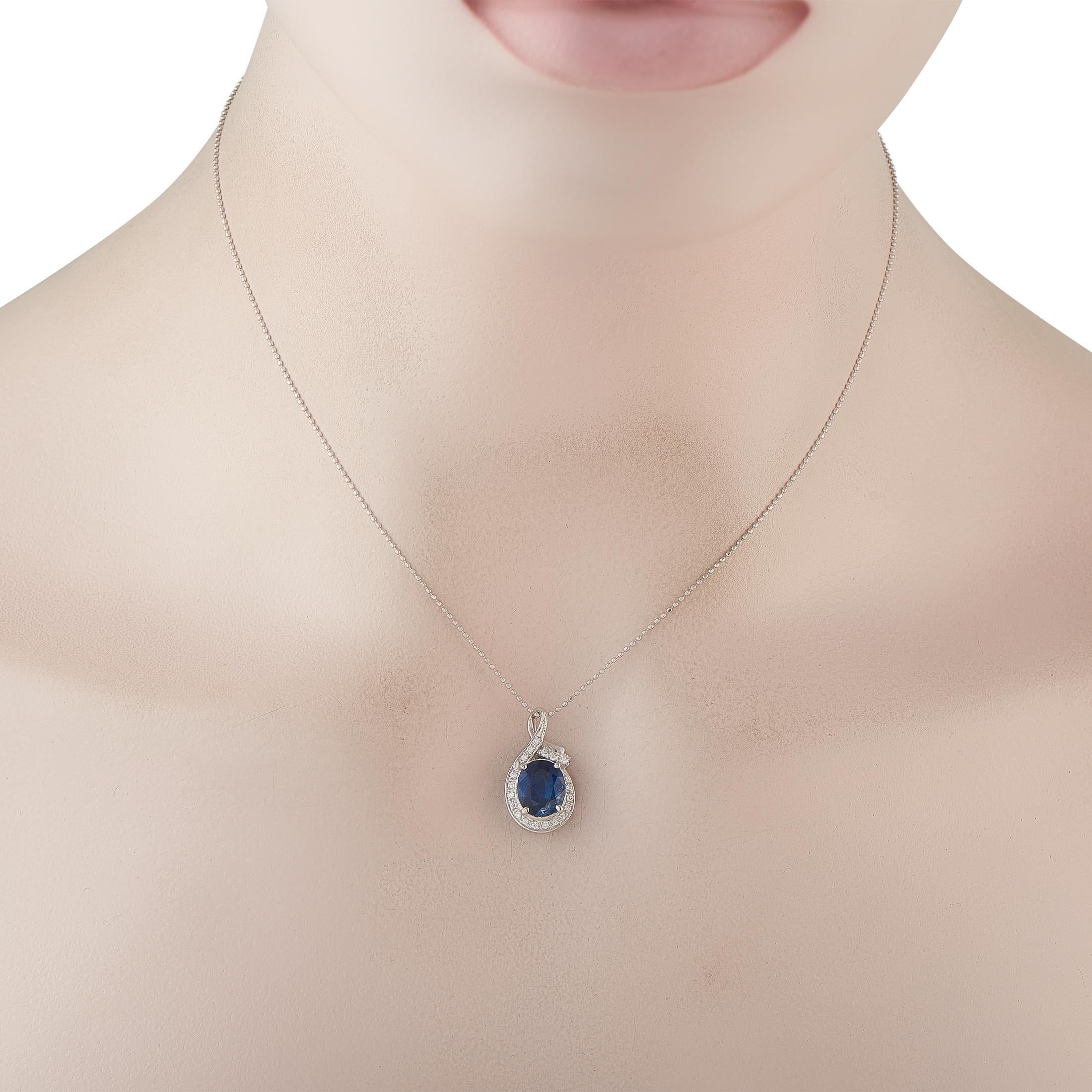 Un collier en platine au design classique mais pas désuet. Cette pièce se compose d'une chaîne en perles de riz avec un fermoir à anneau à ressort, portant un pendentif en diamant et saphir. Le saphir ovale de 2,49 ct est encadré par un ruban de