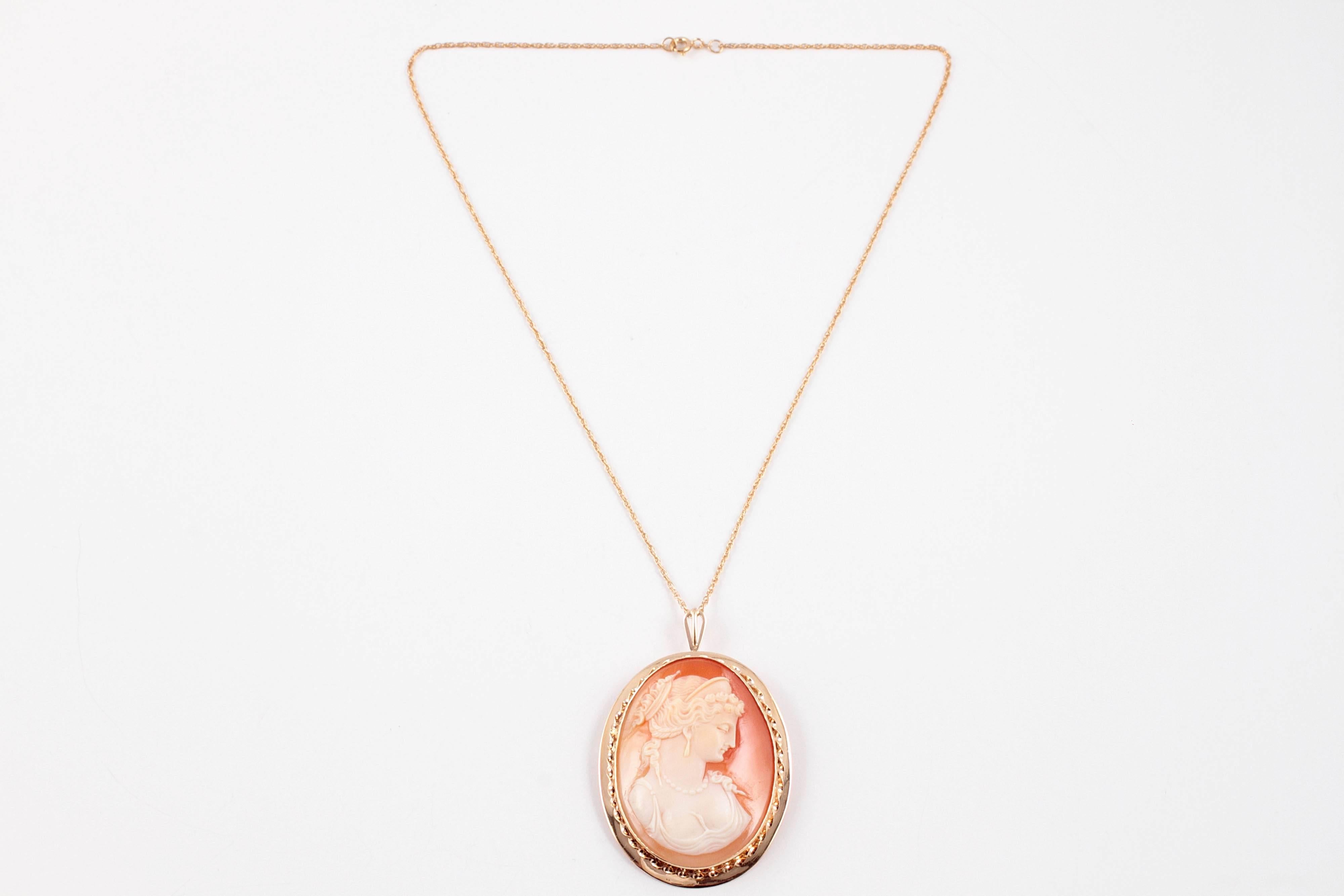 Vintage cameo pendant in 14 karat yellow gold on 18 inch gold filled chain.  Can also be worn as a pin.