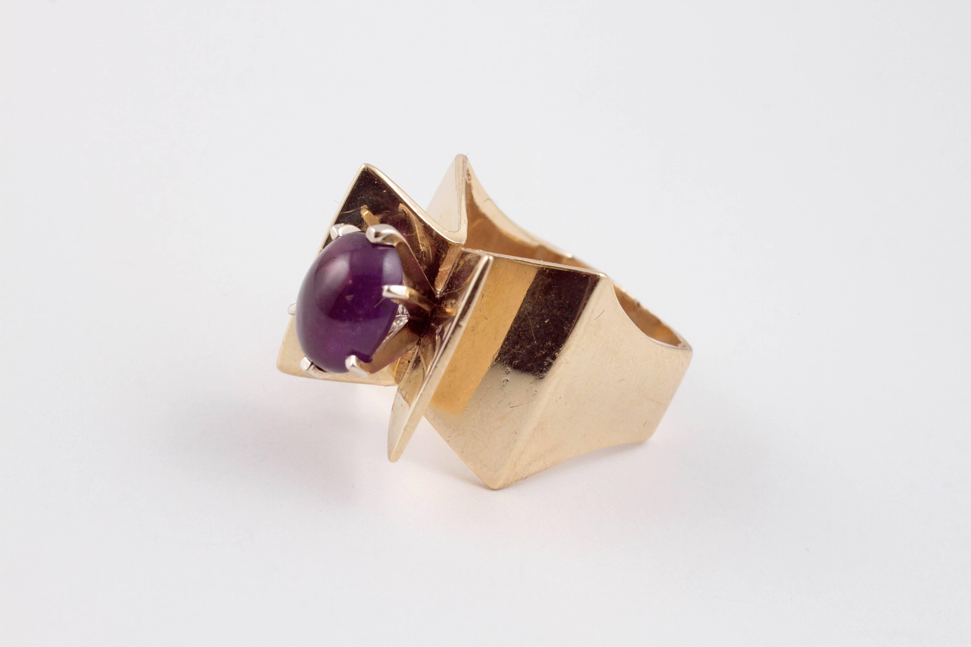 You won't find too many like this one!  In 14 karat yellow gold, with a prong-set, oval-shaped, cabochon-cut amethyst in size 6 1/2.