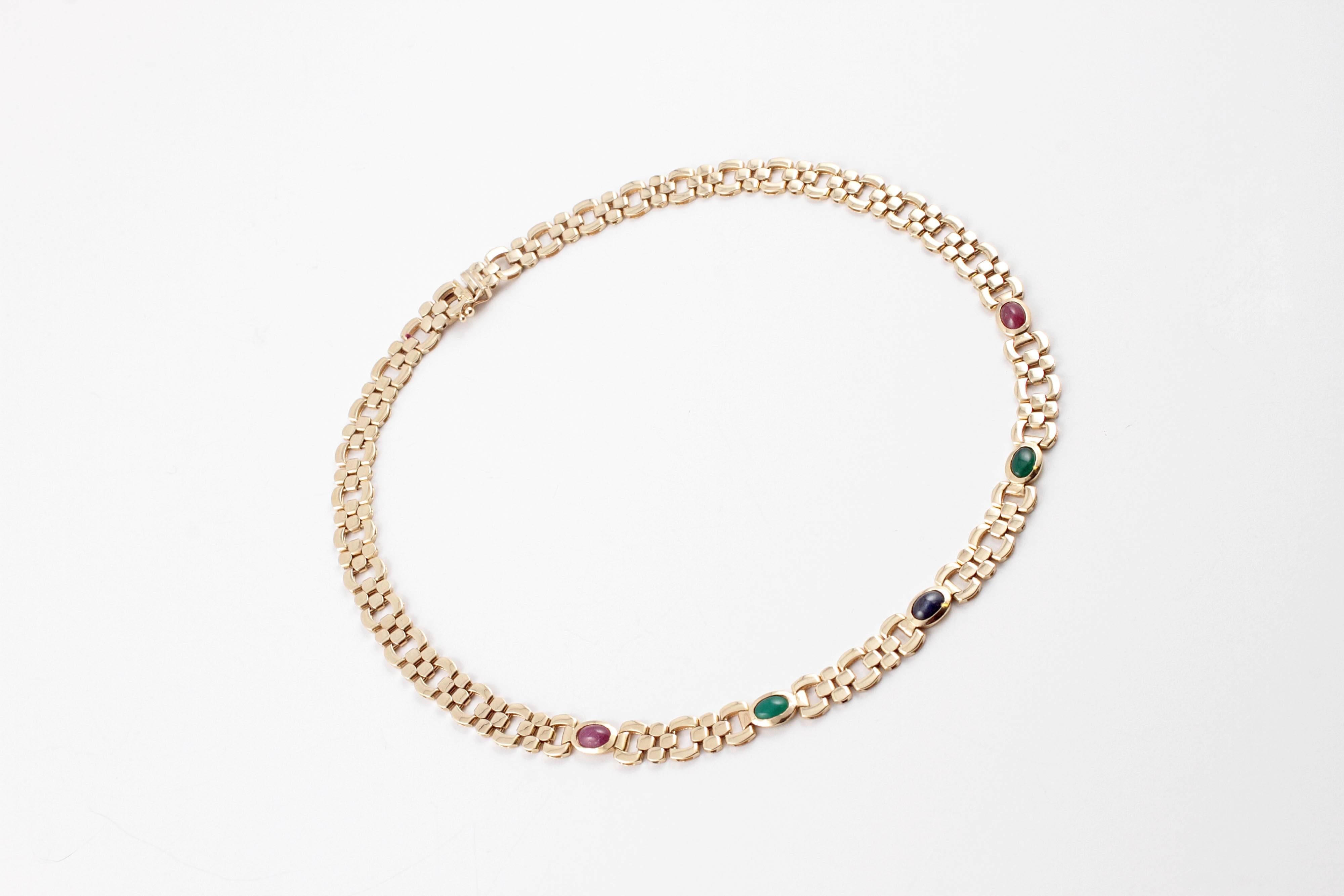 A stunner in 14 karat yellow gold, featuring bezel-set, cabochon-cut rubies, emeralds and one blue sapphire.  17 inches in length.