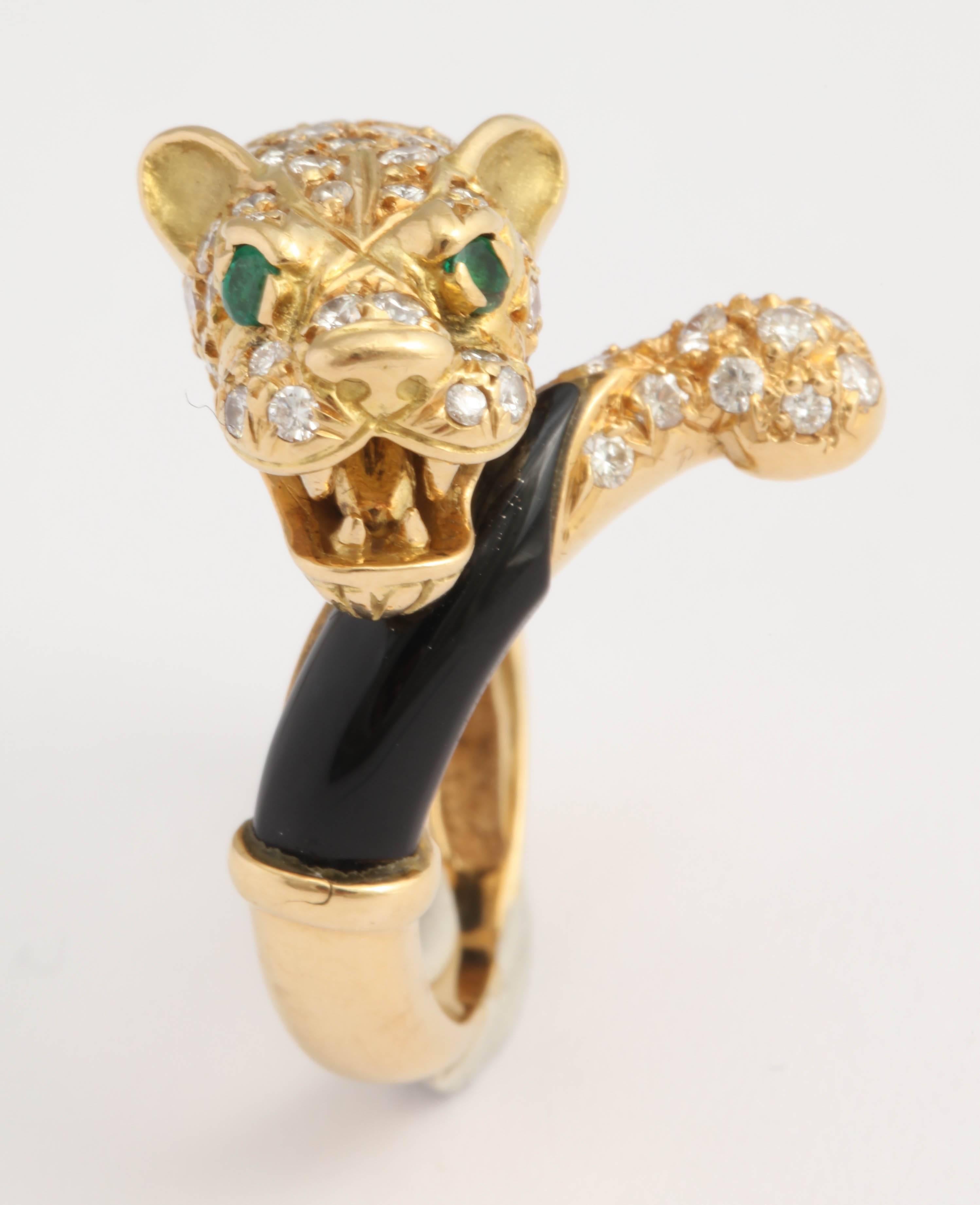 18kt Yellow Gold and black Onyx Lion ring set with a diamond studded Head and Tail.  Eyes are set with vibrant Emeralds.  Can be sized .  Presently a size 8.  Ultra chic and stylish.  Grrrrrrrrrr!