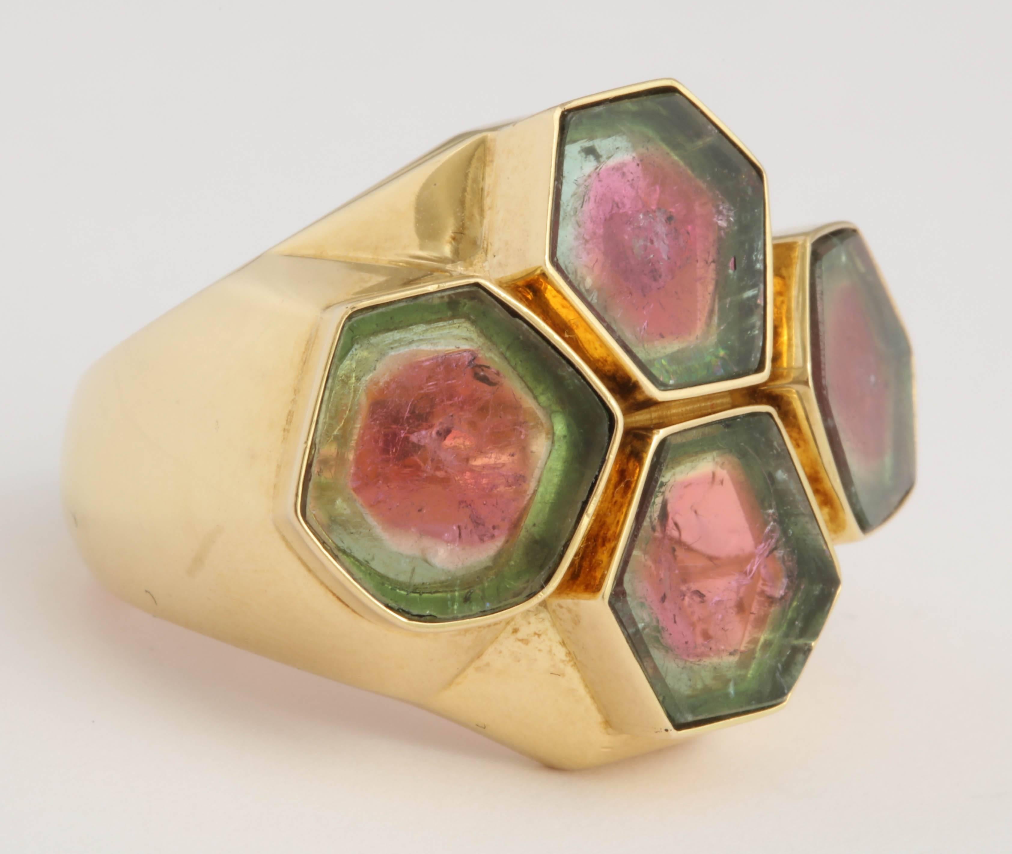 Very unusual 18kt Yellow Gold Ring set with 4 slices of watermelon Tourmaline in hexagonal bevel set mountings.  Very Bombastic in a quiet way. Size 7 but can be sized