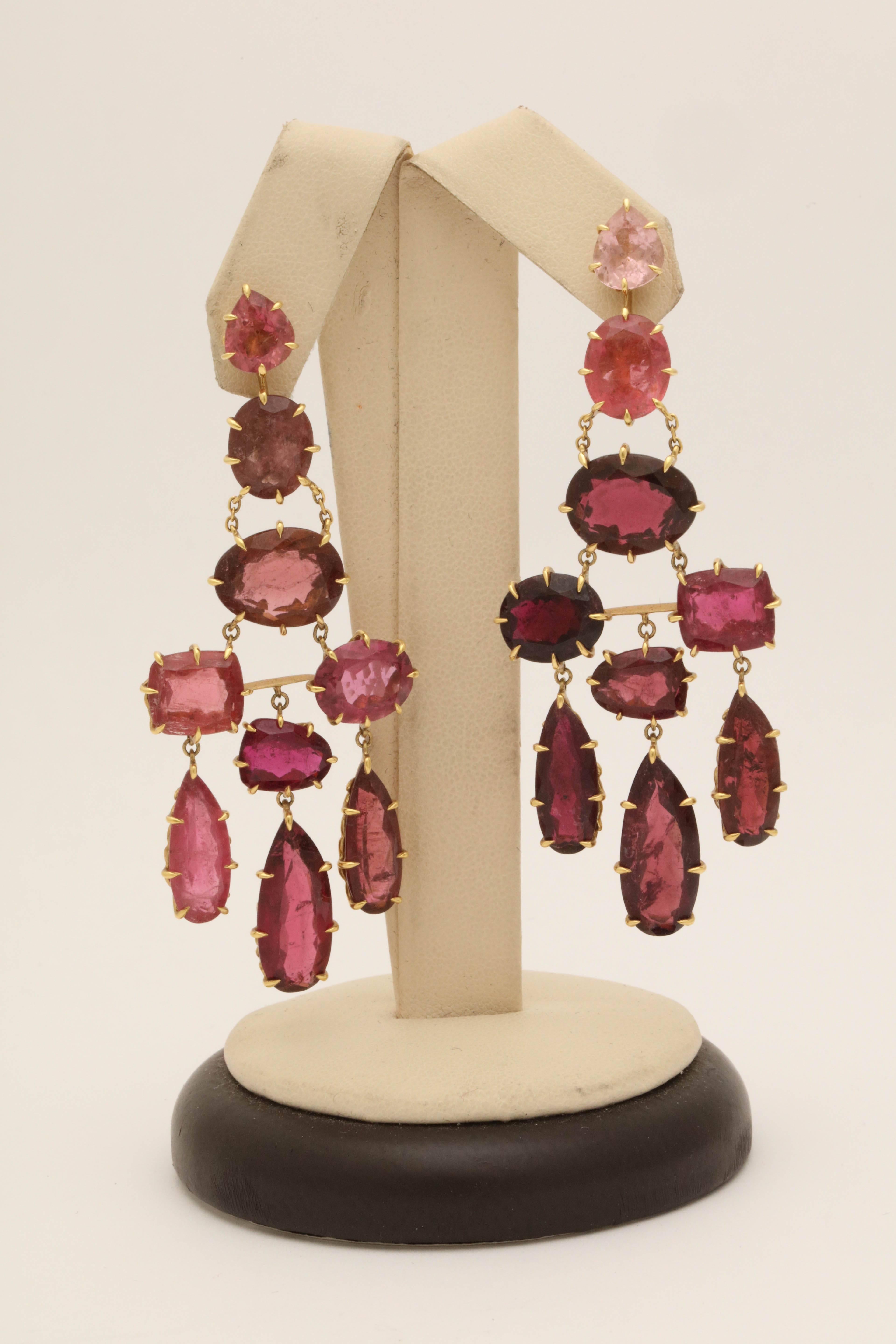 One Pair Of Ladies Flexible And Moveable Earrings Embellished With Numerous Faceted Pink Tourmalines And Faceted Garnet Stones. Each Stone Set In A Beautiful Crown Prong Setting For Extra Security. Total Carat Weight Of All Stones approximately 20