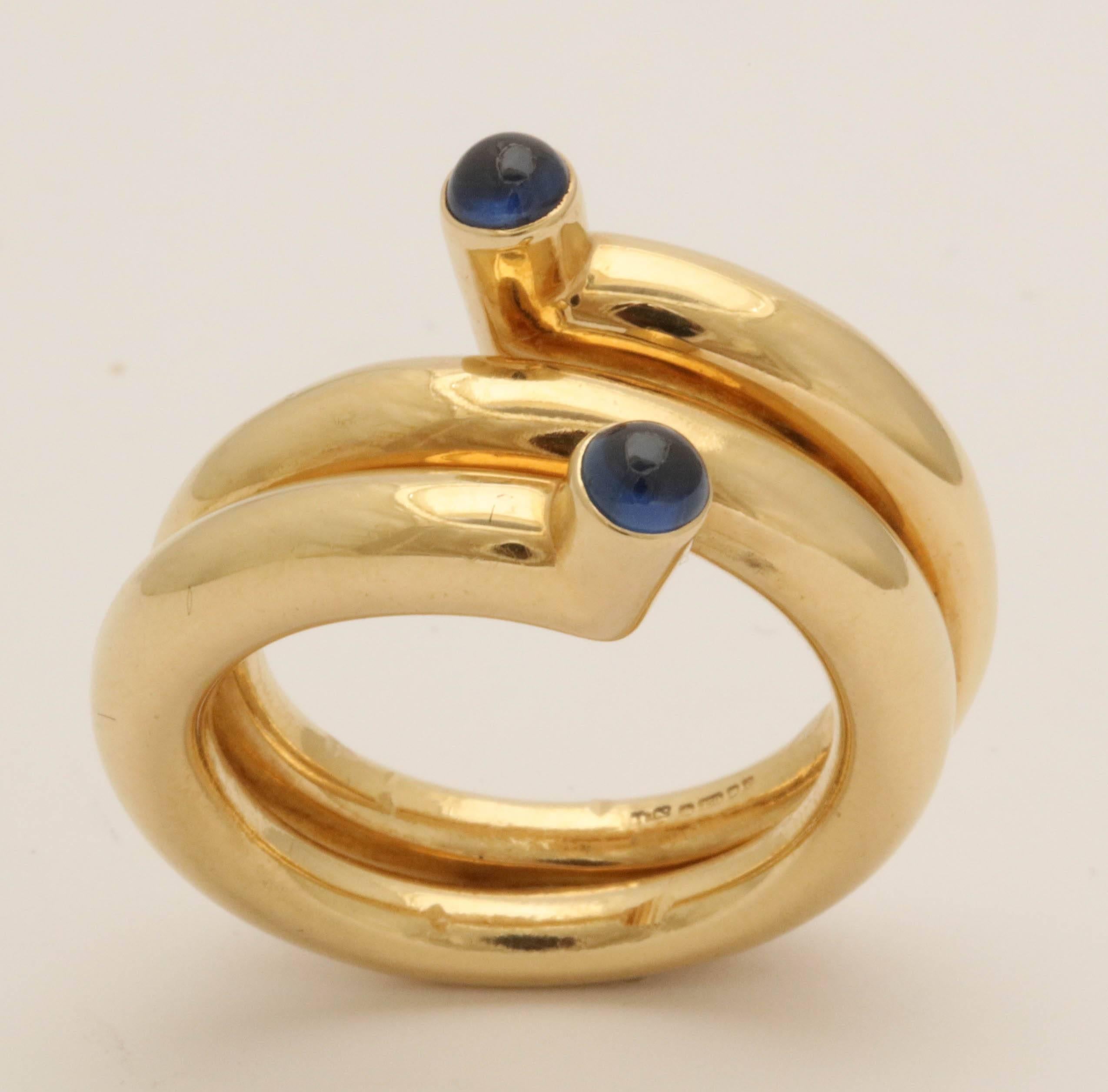 One 18kt High Polish  Heavy 18kt Yellow Gold Wrap Twist Design In The Form Of A Coil Band Ring Embellished With Two High Quality Beautiful Color Cabochon Sapphires. Ring Averaging Around A Size 8 & 1/2 American Size. Designed By Schlumberger For