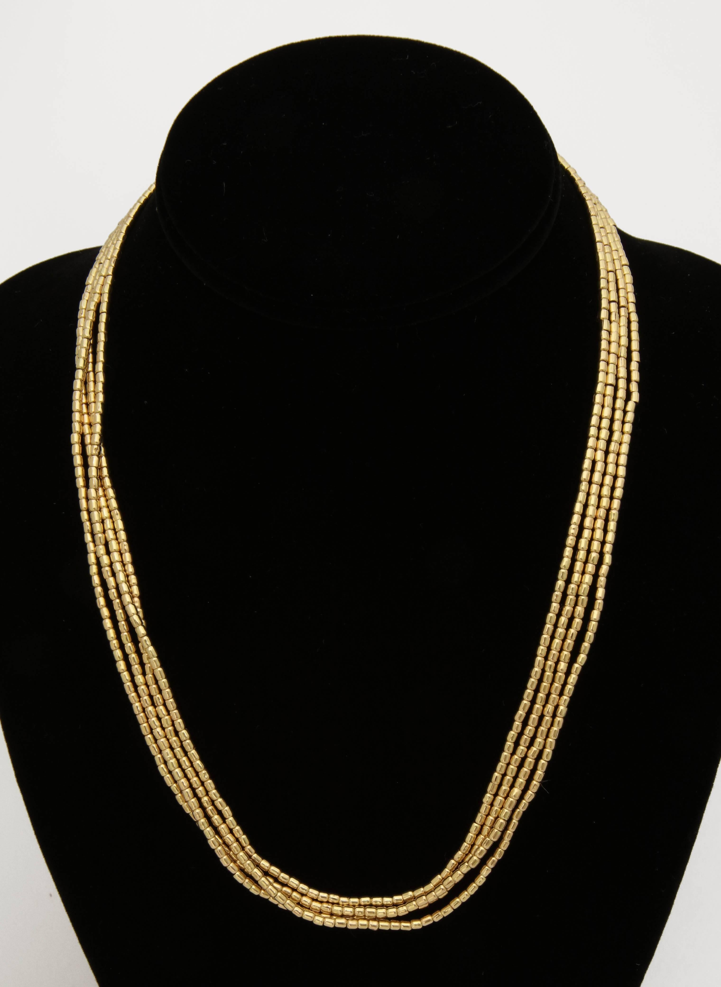 One Unisex Long Lariat Stlye Chain Necklace Composed Of Numerous 18kt Yellow Gold Pellet Beads. May Be Wrapped around Your Neck Four Times Or Six Times to Be Worn On Your Wrist. Strung On cord for Flexiblity And Exemplfying a Beautiful rich Color
