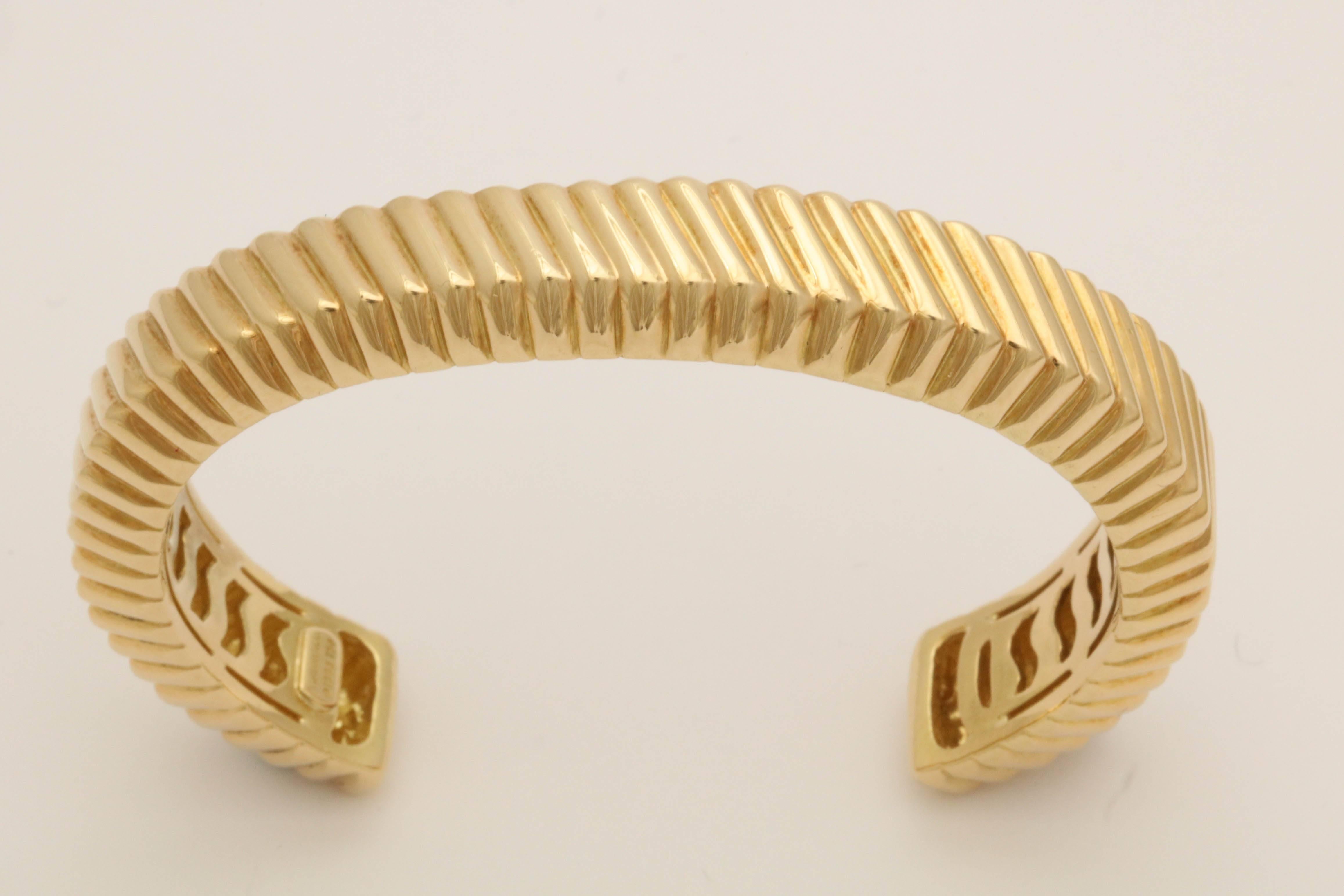 One Unisex Open Back Bangle Cuff bracelet Designed With Diagonal Ridges Textured Gold Workmanship. Beautifully Finished Off With An Openwork Design Dtail On The Inside Of The Bracelet. Created By Tiffany & Co. Dated 1998.Note; May Be Worn on The