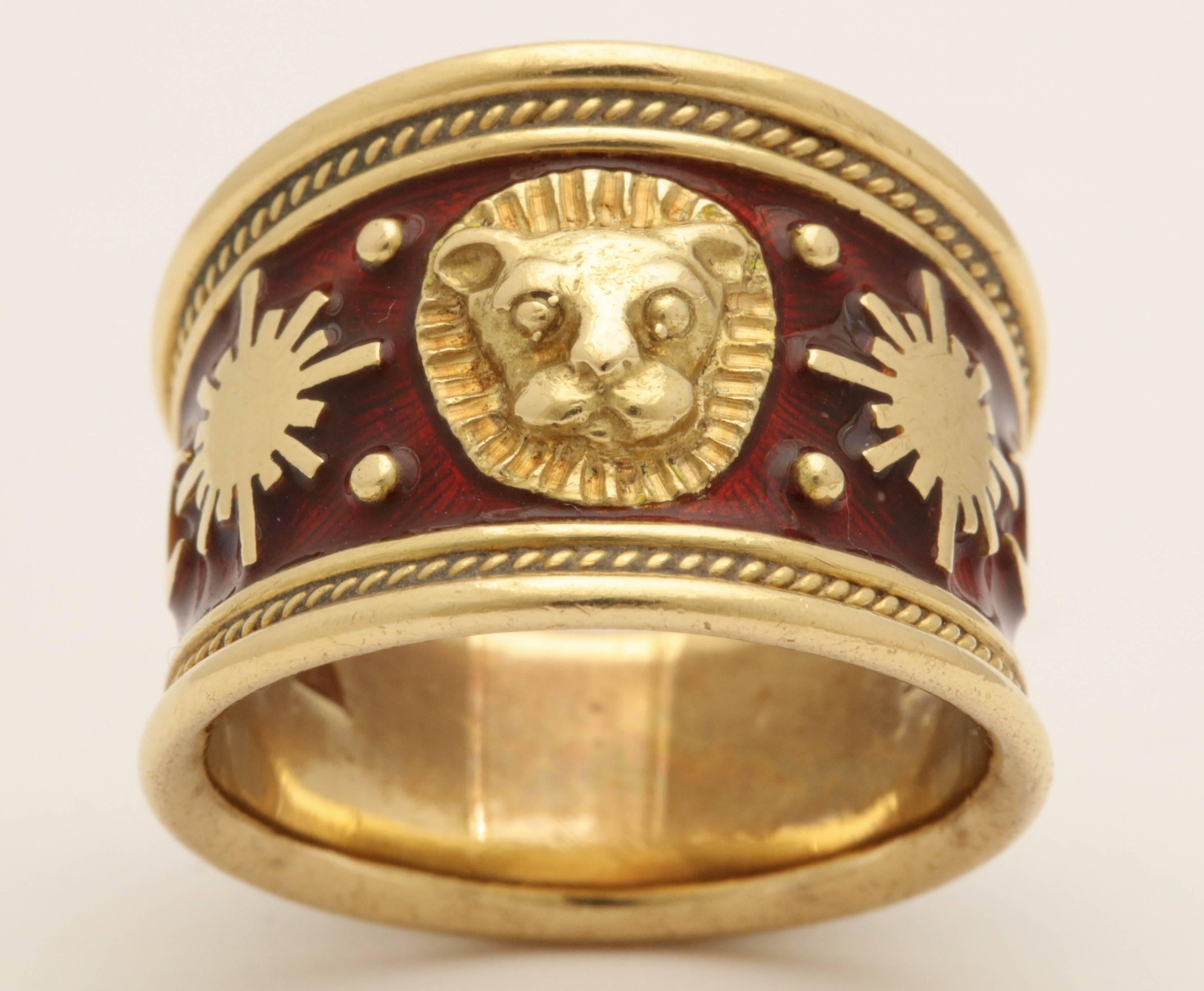 One Unisex Ring Designed In 18kt Yellow Gold With Starburst And Moon Details Centering A Leo The Lion Design Decal In The Center.The Tapered Band Is Further Embellished With Hard Red Guilloche Enamel And Borders Of Ring With A Beautiful Ridged Gold