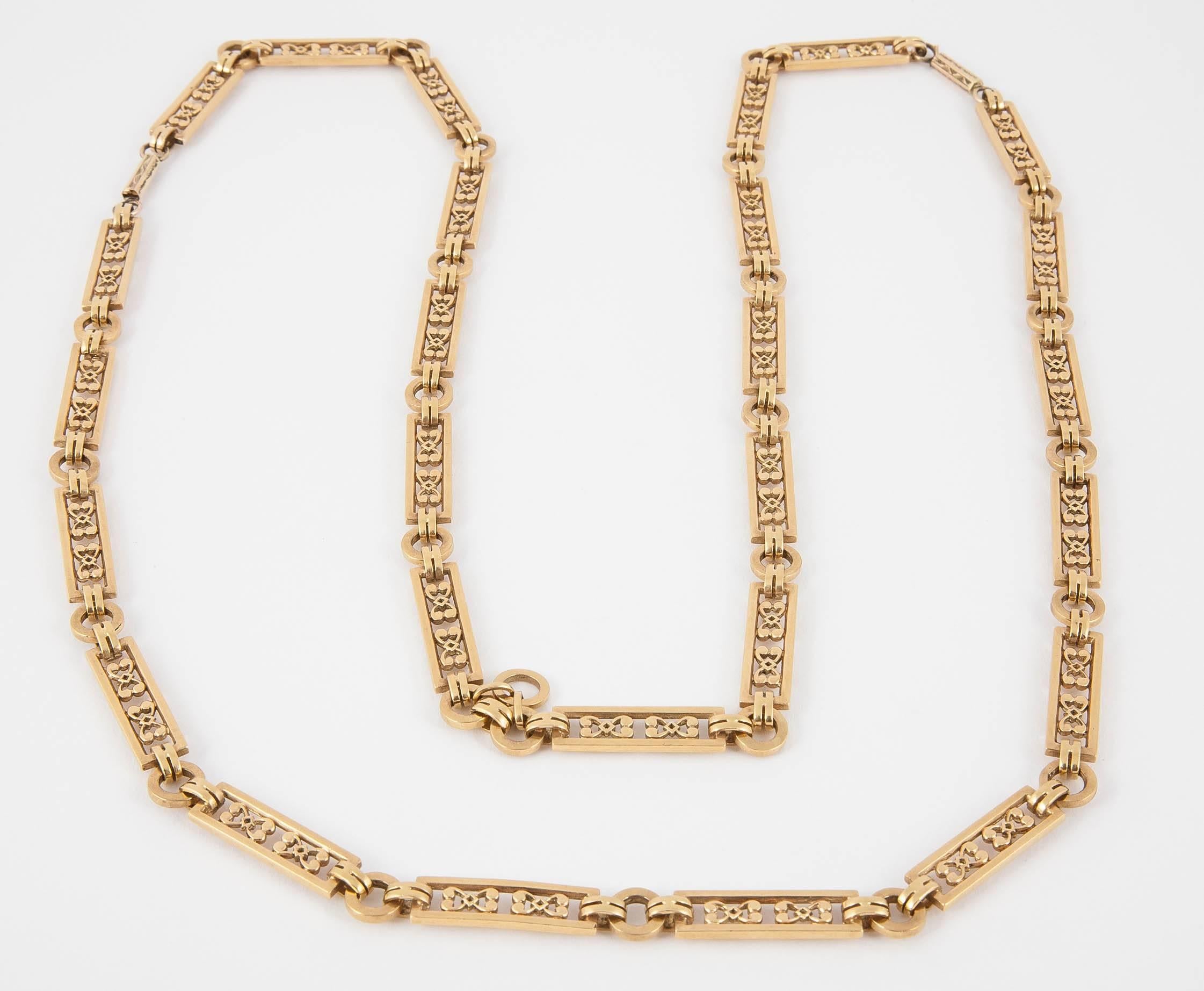 A fine quality heavy gold 18 kt necklace of openwork oblong panels with bow motifs inside. Length 37 inches. Dividing to form two, shorter necklaces, one 17.5 inches long, one 19 inches. C, 1910