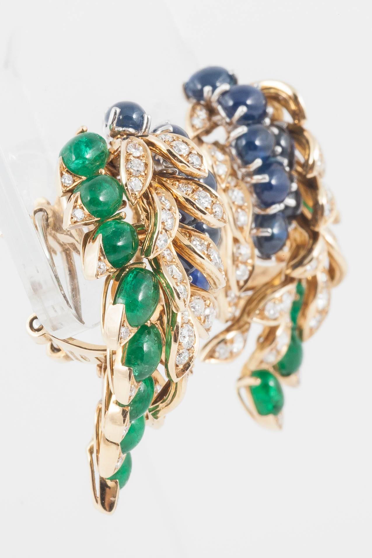 These 1960's 18ct Gold earrings set with natural untreated cabochon - cut Emeralds and Sapphires and round cut Diamonds