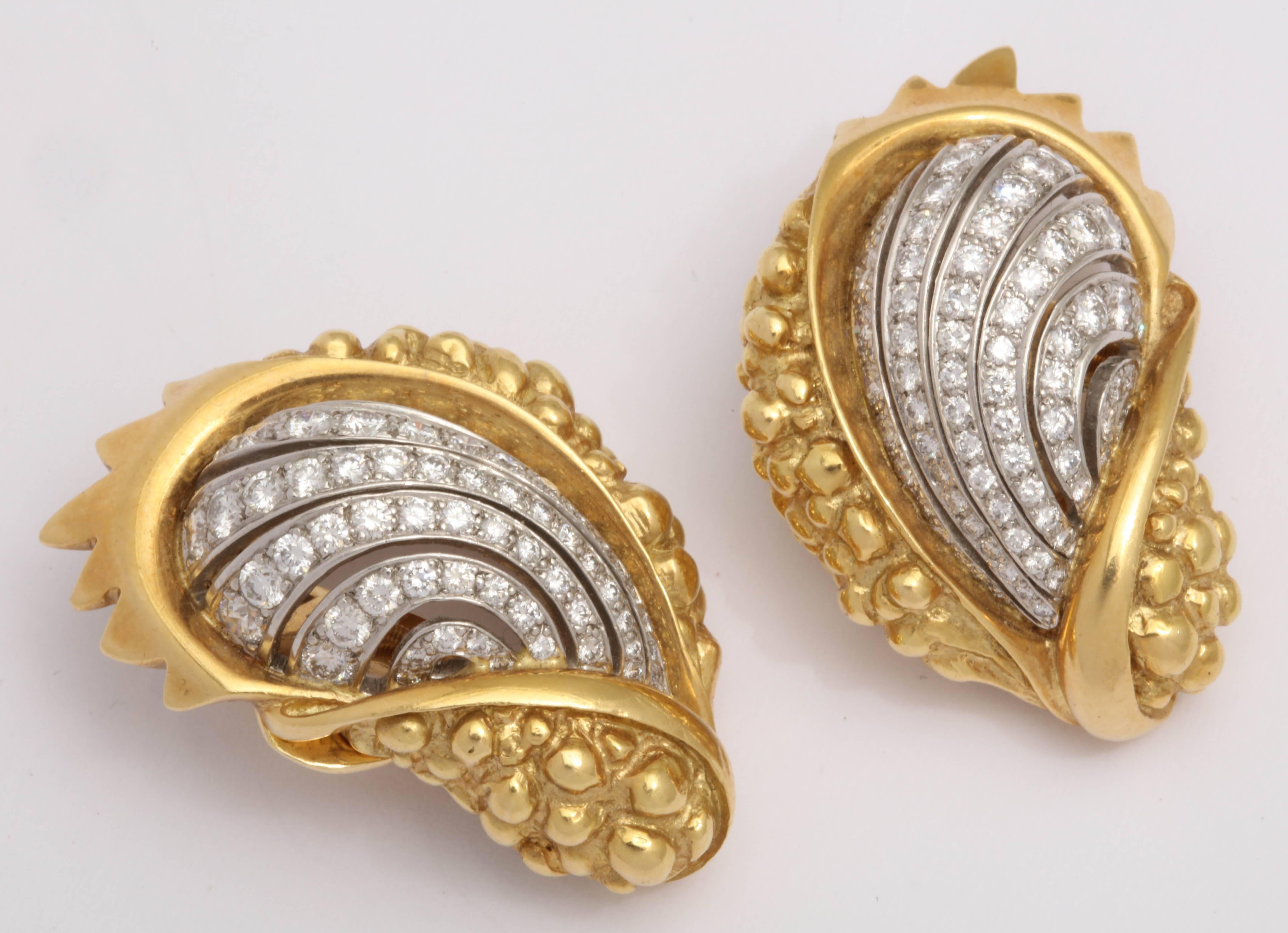 Signed Marilyn Cooperman Clip on Shell Earrings evocative of the Sea in a very sultry manner.  Each  Shell has a pierced  center section, pave set,  with Diamonds in Platinum surrounded by  a shell shape that is sumptuous in 18kt Yellow Gold.  Total