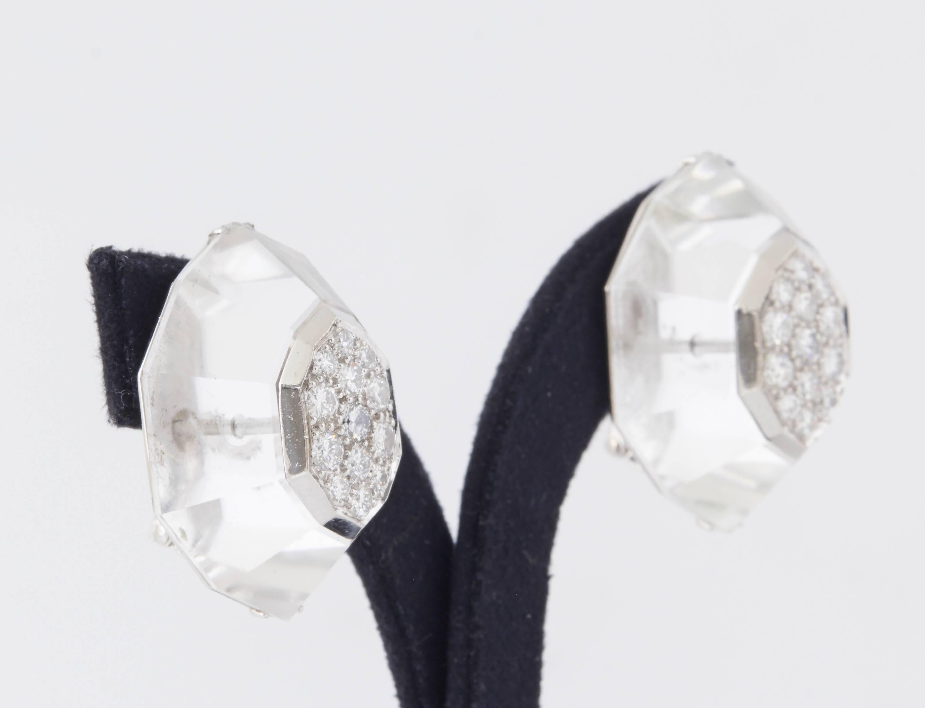 Signed David Webb Rock Crystal earrings finely crafted in 18K gold and platinum, features round cut diamonds weighing a total of 2.50 carats. 