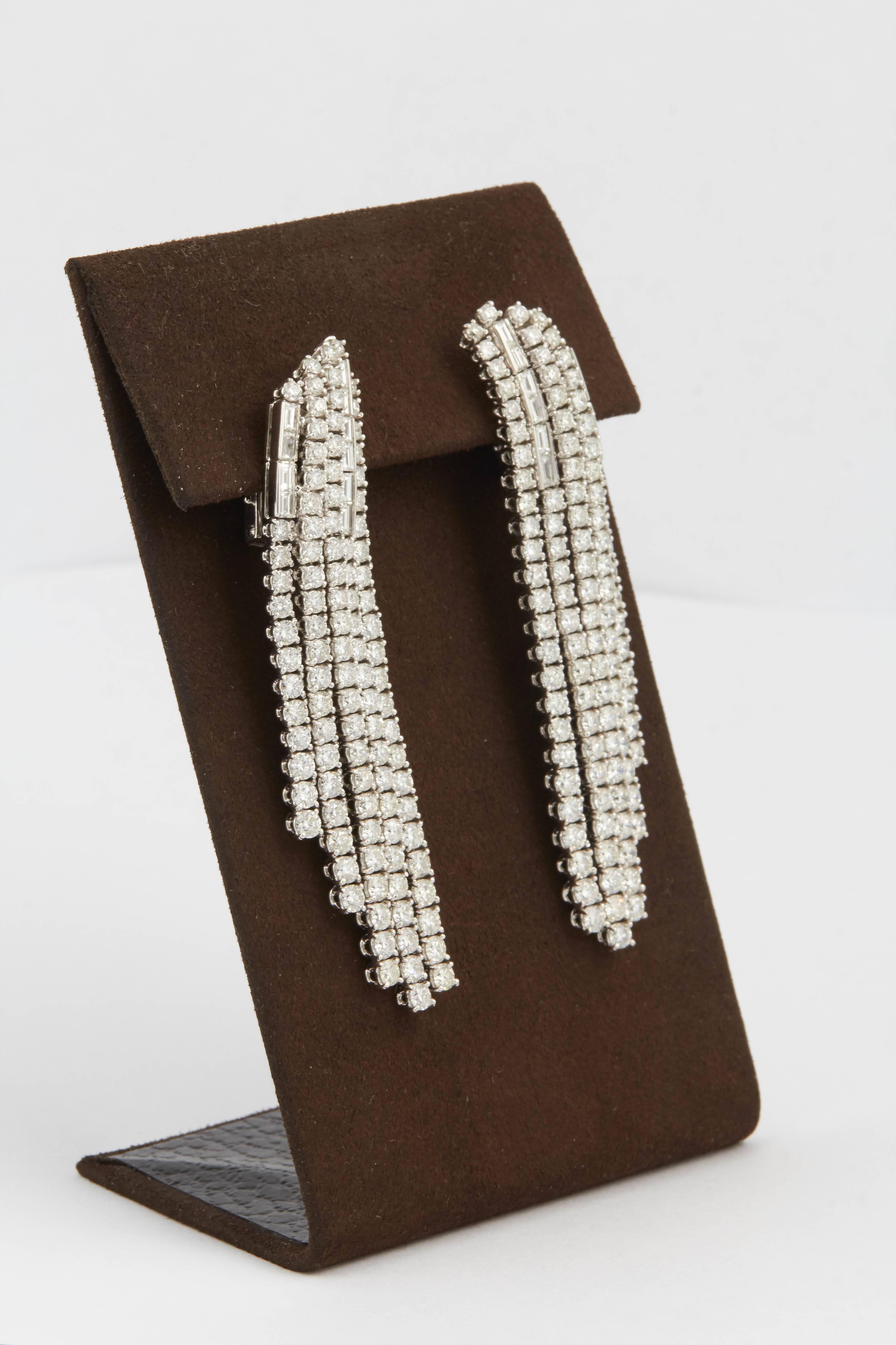 

Like a waterfall of diamonds!!

18.41 carats of round brilliant cut diamonds with subtle baguette diamond accents set in 18k white gold.

F/G VS diamonds

A FABULOUS earrings with great movement and presence.

Just over 3 inches long from its