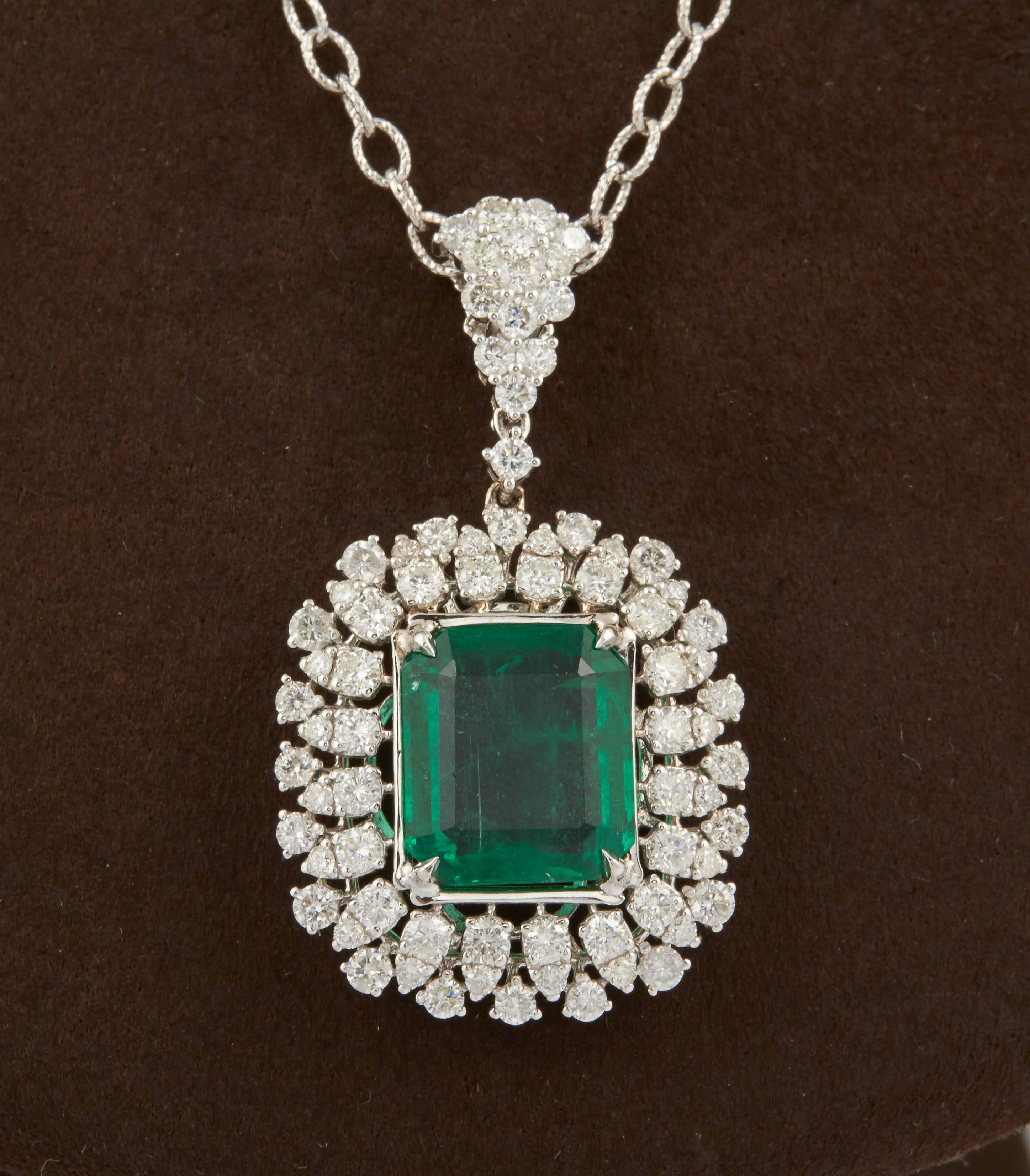 

A stunning pendant!

5.95 carat fine Green Emerald with rich color and luster surrounded by white diamonds.

2.85 carats of white round brilliant cut diamonds.

16 inch 14k white gold fancy chain. 

The pendant portion is approximately an inch