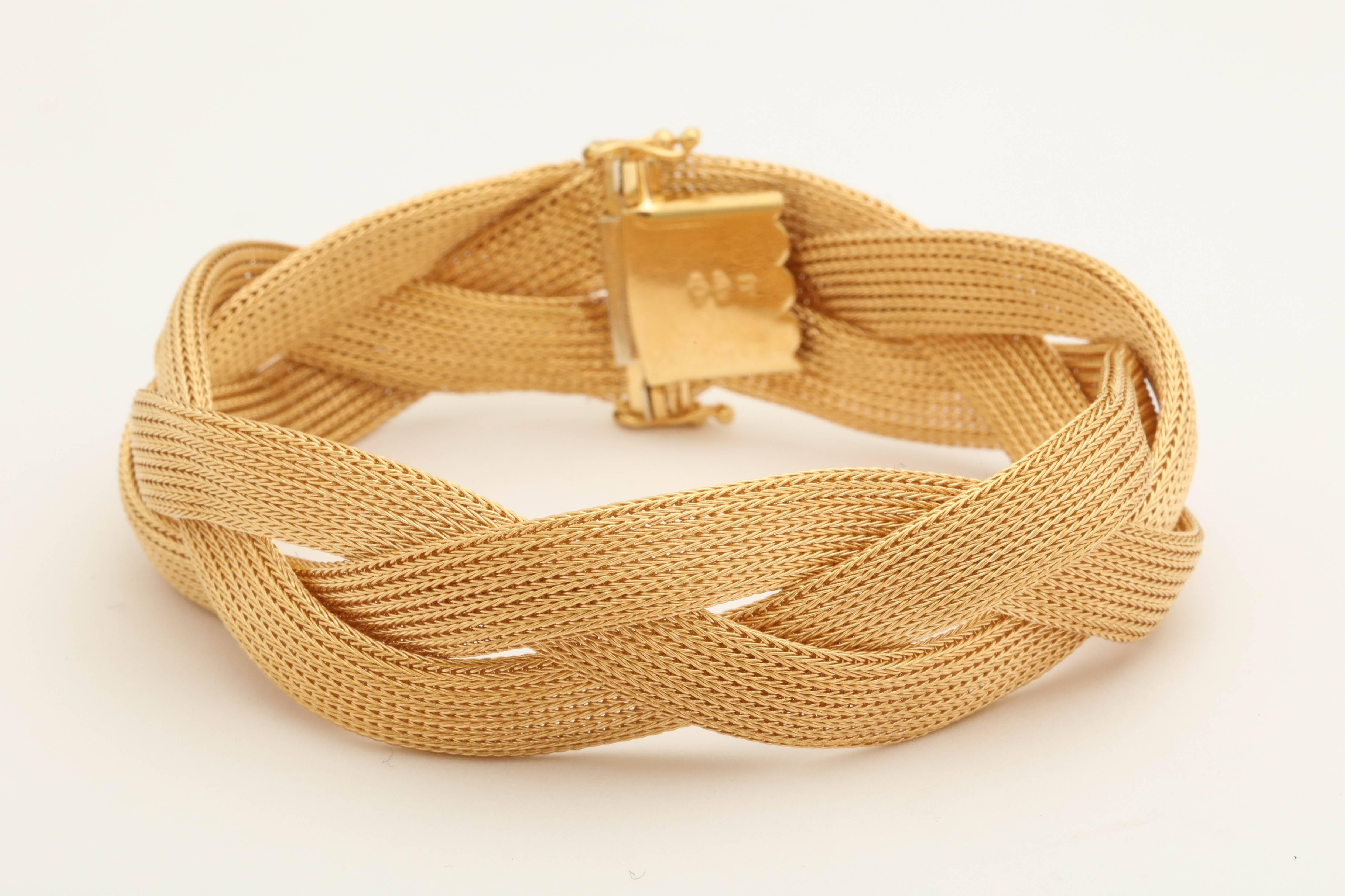 One Textured 18kt Gold Flexible And Soft And Smooth To The Wrist Bracelet Made In A Twisted And Braided Design To Create An Interwined Woven Knot Effect.Made In Italy In The 1950's. NOTE: Two Figure Eight Safety Locks For Extra Security.