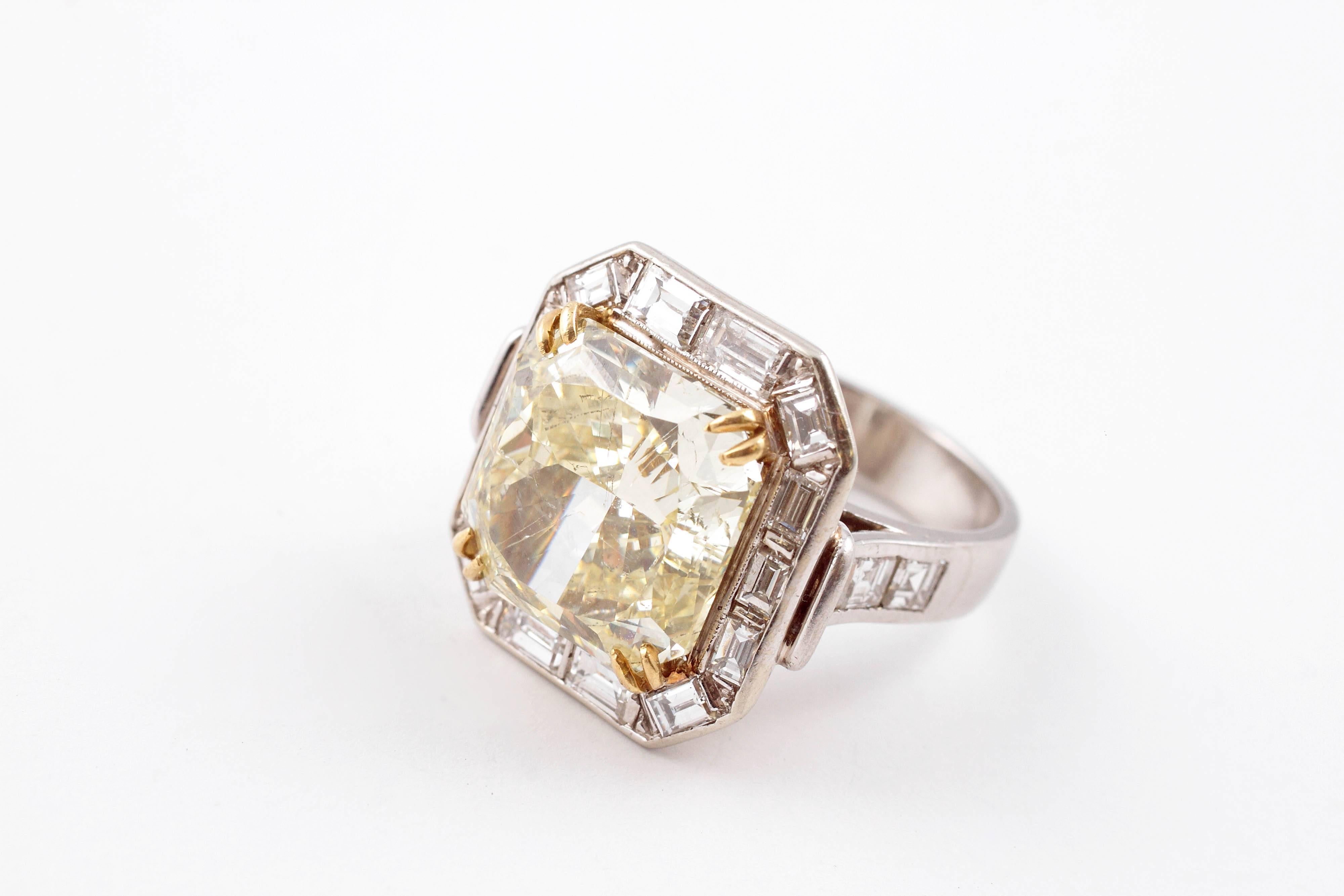 Hello sunshine!   The GIA has graded this lovely 10.26 carat diamond as fancy yellow.  The center gem is nearly square measuring 12.85 x 12.75 and is surrounded with 2.90 carats of baguette accents in filigree platinum shank.  Size 6.25.