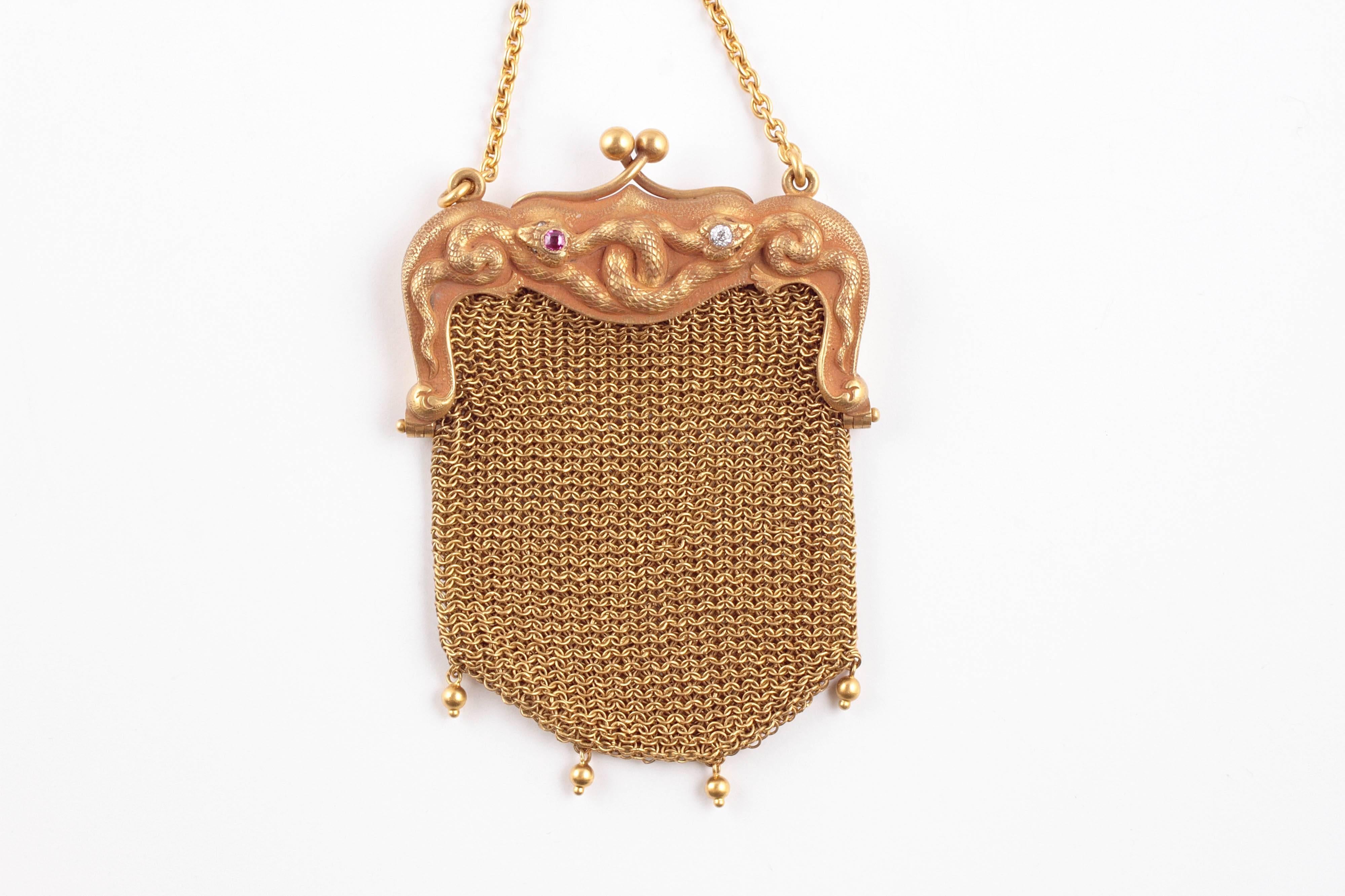 Interesting ring purse from Sloan and Co. with diamond and ruby accented snakes in 14 Karat gold mesh.  The ring portion is size 8 1/4.