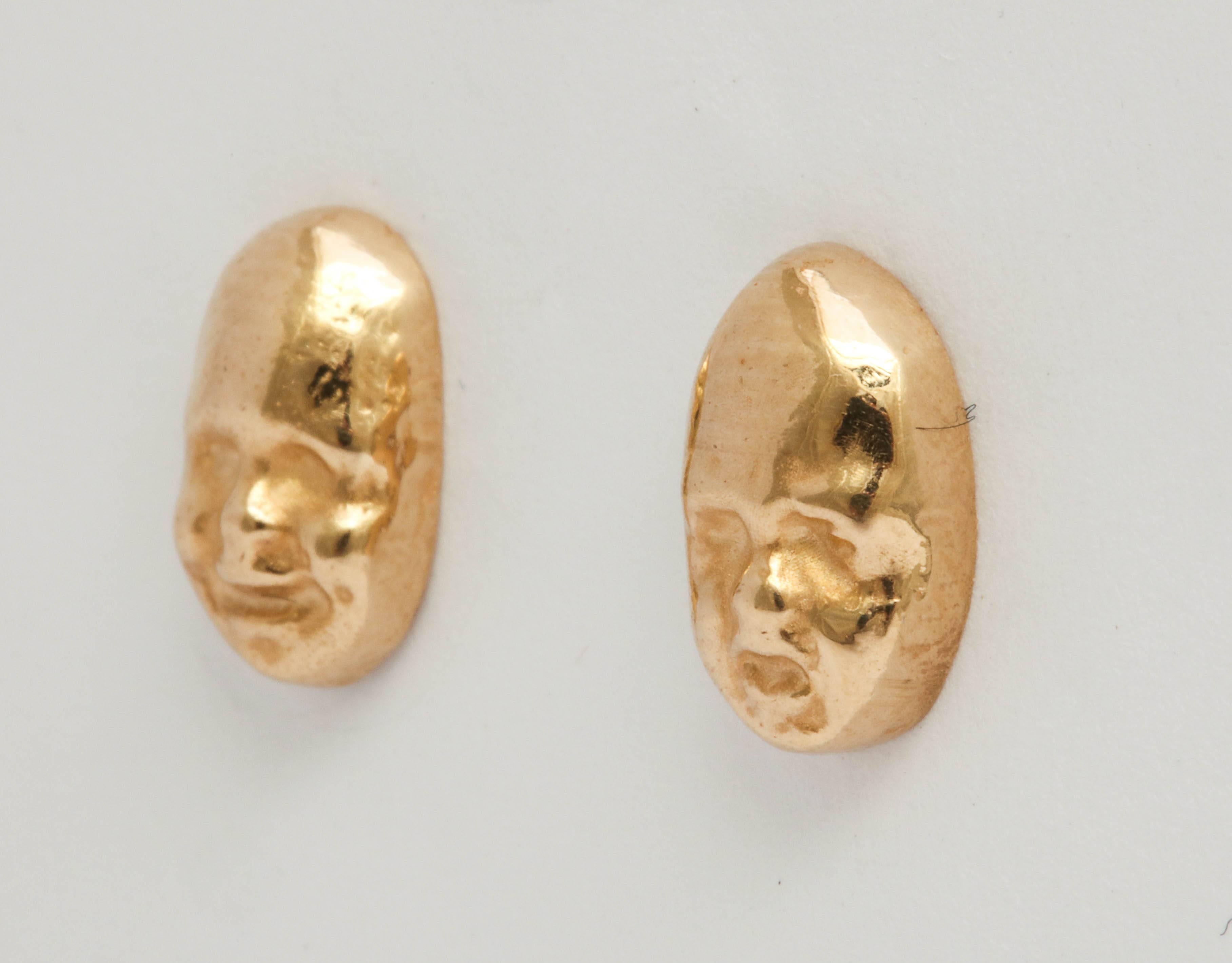 Pair of Tragedy and Comedy Masks earrings in polished 14k yellow gold, mounted on gold posts.  

21st century, or contemporary.

Masks measure ½ x ¼ x ¼ in. (1.3 x .6 x .6 cm.) (l x w x h)