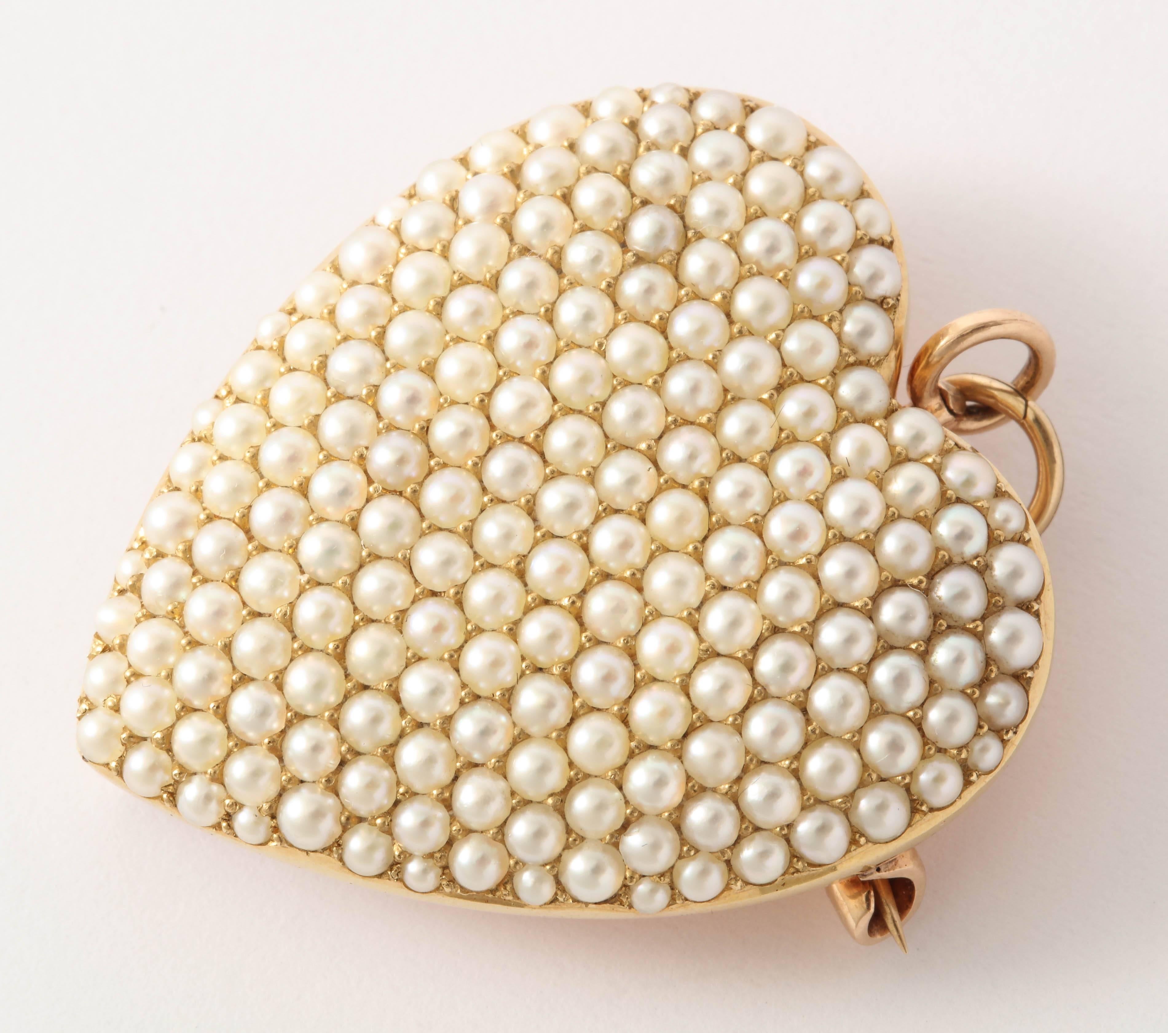 Quite large in size, this lovely American late Victorian seed pearl heart can be worn as either a brooch or pendant. It also has a hook should you want to dangle something beneath. 