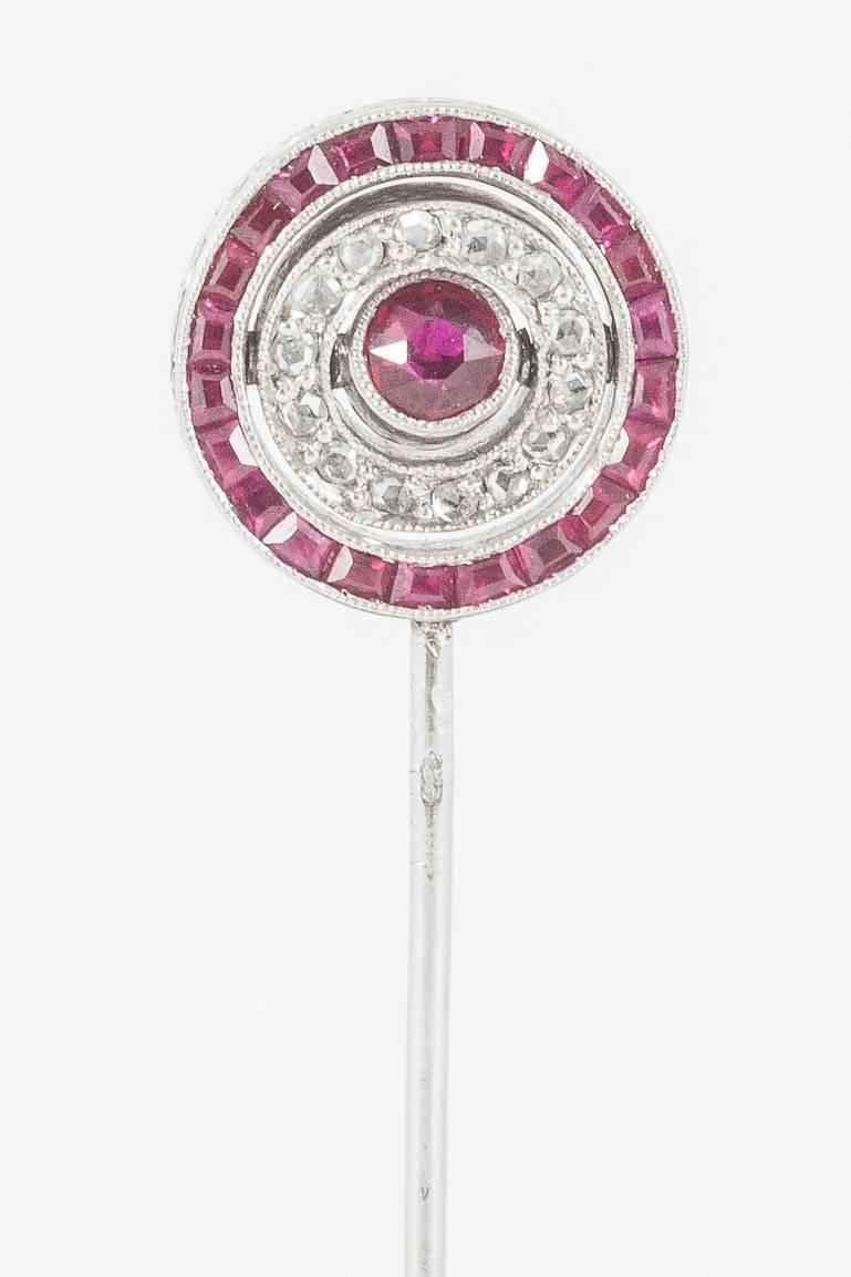 A rare and exceptional quality tiepin in the form of a winning post,one side set with brilliant and rose cut diamonds,the other of fine coloured calibre set burma rubies.the centre collet and surrounding cluster revolves, to show different