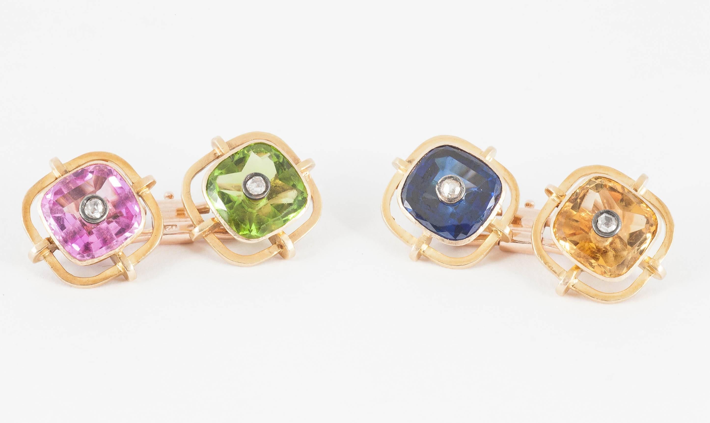An unusual pair of gold mounted cufflinks set with a green peridot,yellow citrine,blue paste [glass] and pink paste [glass] each with a rose cut diamond centre,heavy quality,c,1920