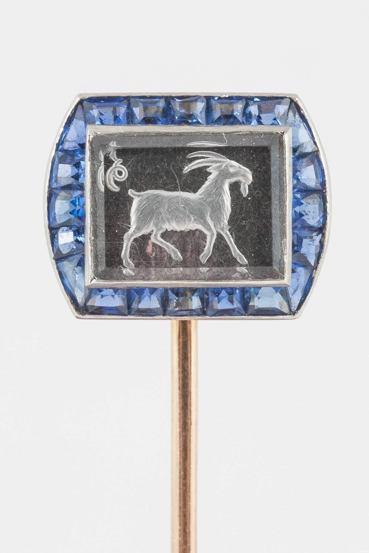 A fine quality Art Deco crystal tie pin carved in relief with a goat surrounded by very good coloured calibre set Ceylon sapphires. Set in gold and mounted in platinum. Numbered 43733
Measures 13mm in width x 10mm in height.
Antique piece (over 100