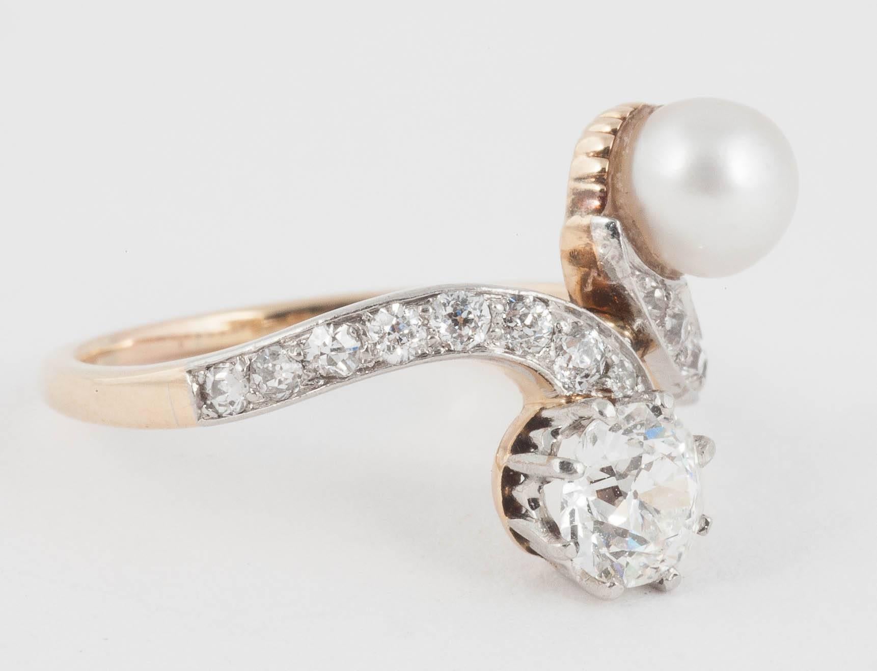 This Edwardian crossover ring has a 5.2 mm Pearl and .75 cts of Diamonds set in Platinum and 18ct Gold
Finger size L