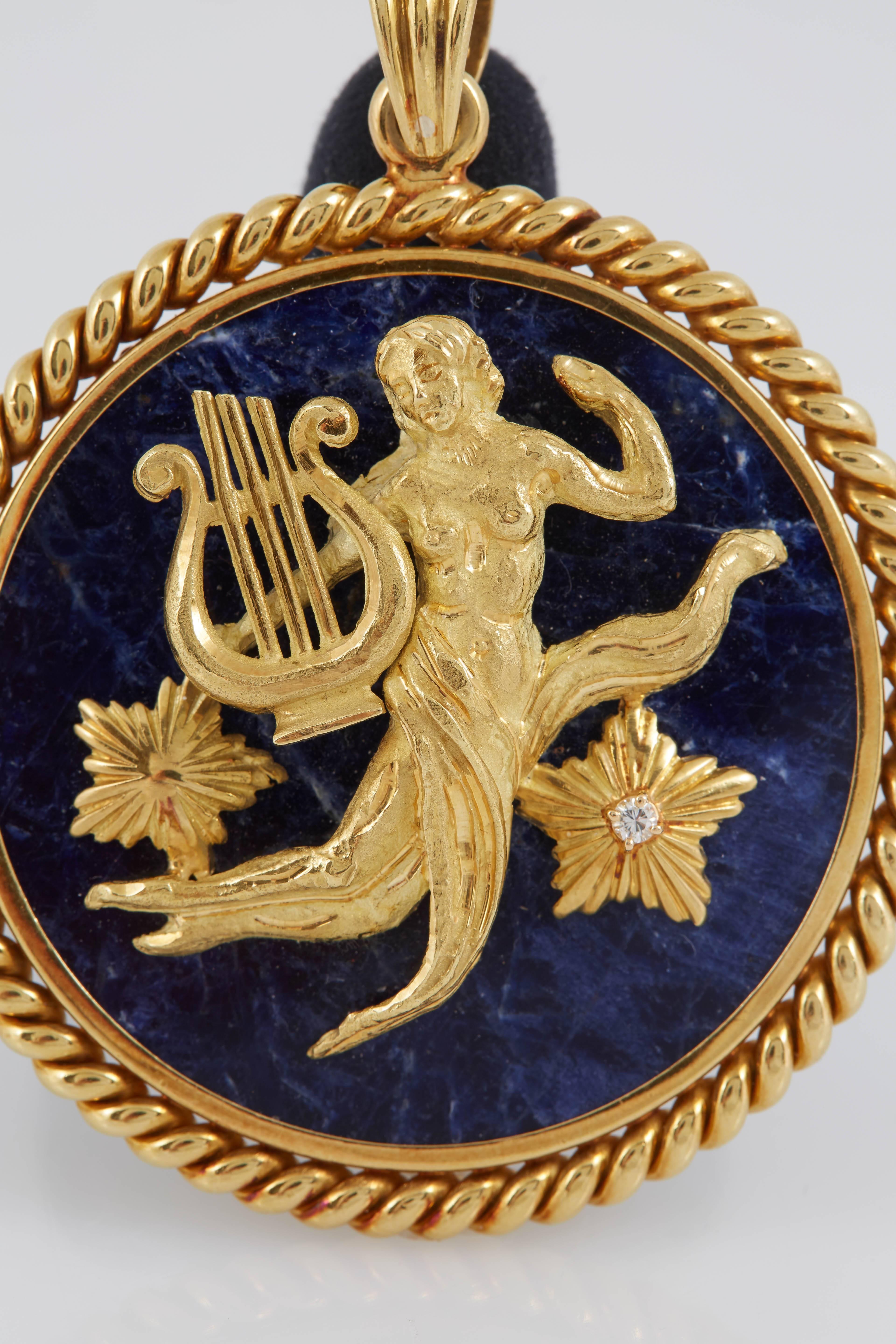 Signed Van Cleef & Arpels Virgo Zodiac Pendant.The Virgo figure at the center of the disc is made of 18K yellow gold and one of the stars is encrusted with a diamond at the center. The Lapis Lazuli disc is framed in 18K yellow gold as well. This