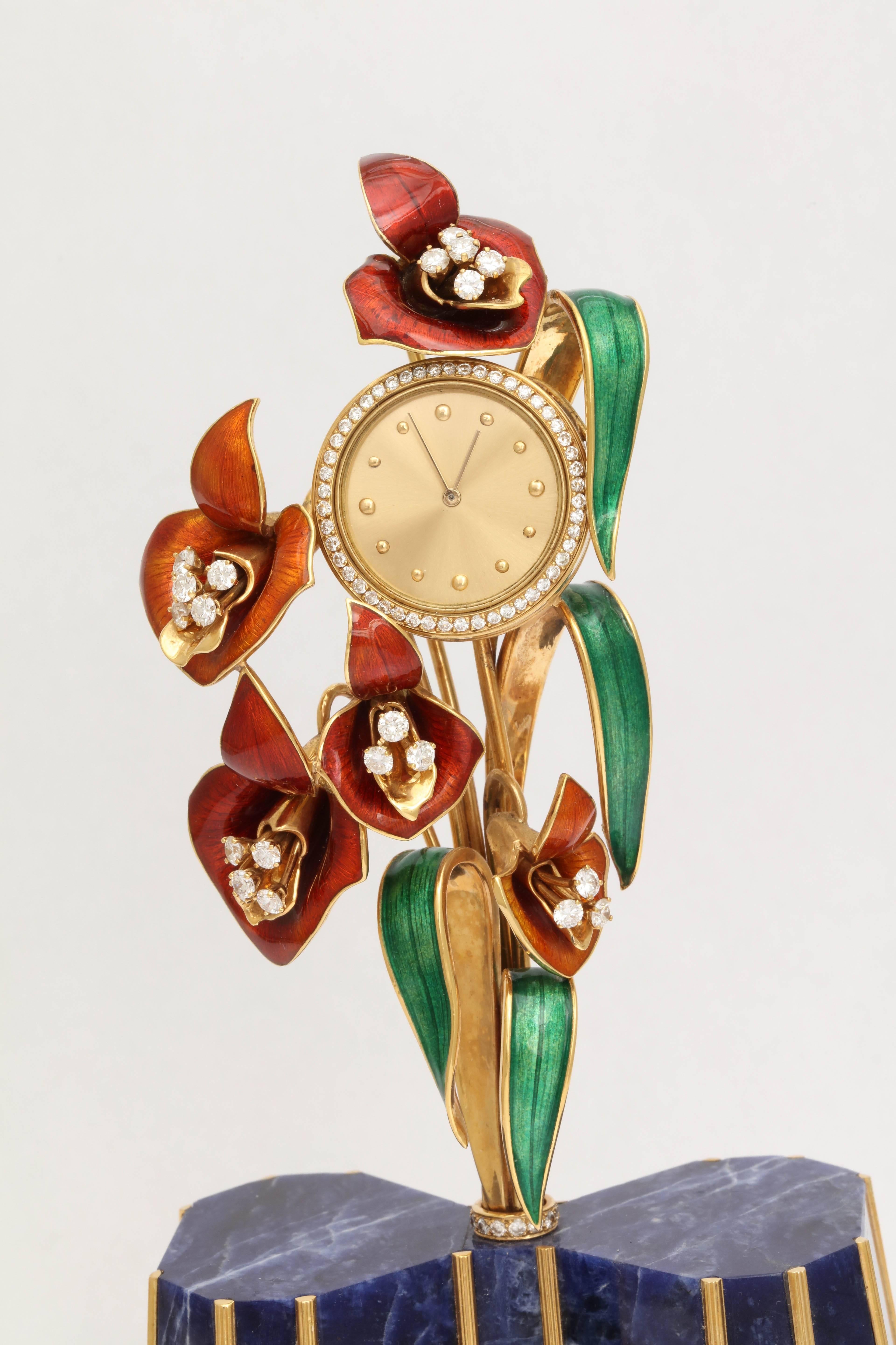 Wonderful & whimsical.  Solid 18kt Yellow Gold & Enamel Floral Sprig growing out of a Gold decorated Lapis Base. 
The Flower is made up of 5 enamel Flowers, each centered with 3 enamel Flowers set and with 5 full cut clean white Diamonds