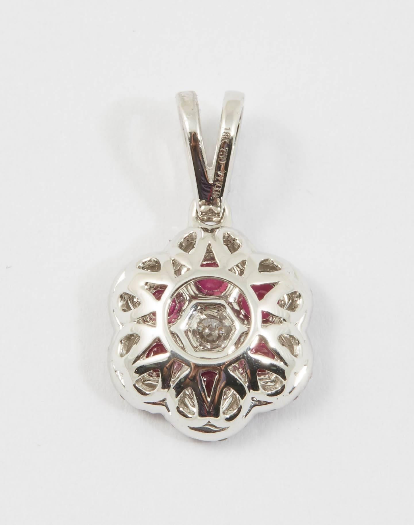 18 K white gold, 1.8 g.
6 Ruby : 0.71 cts.
44 round diamonds : 0.33 cts.
measures 5/8 of an inch