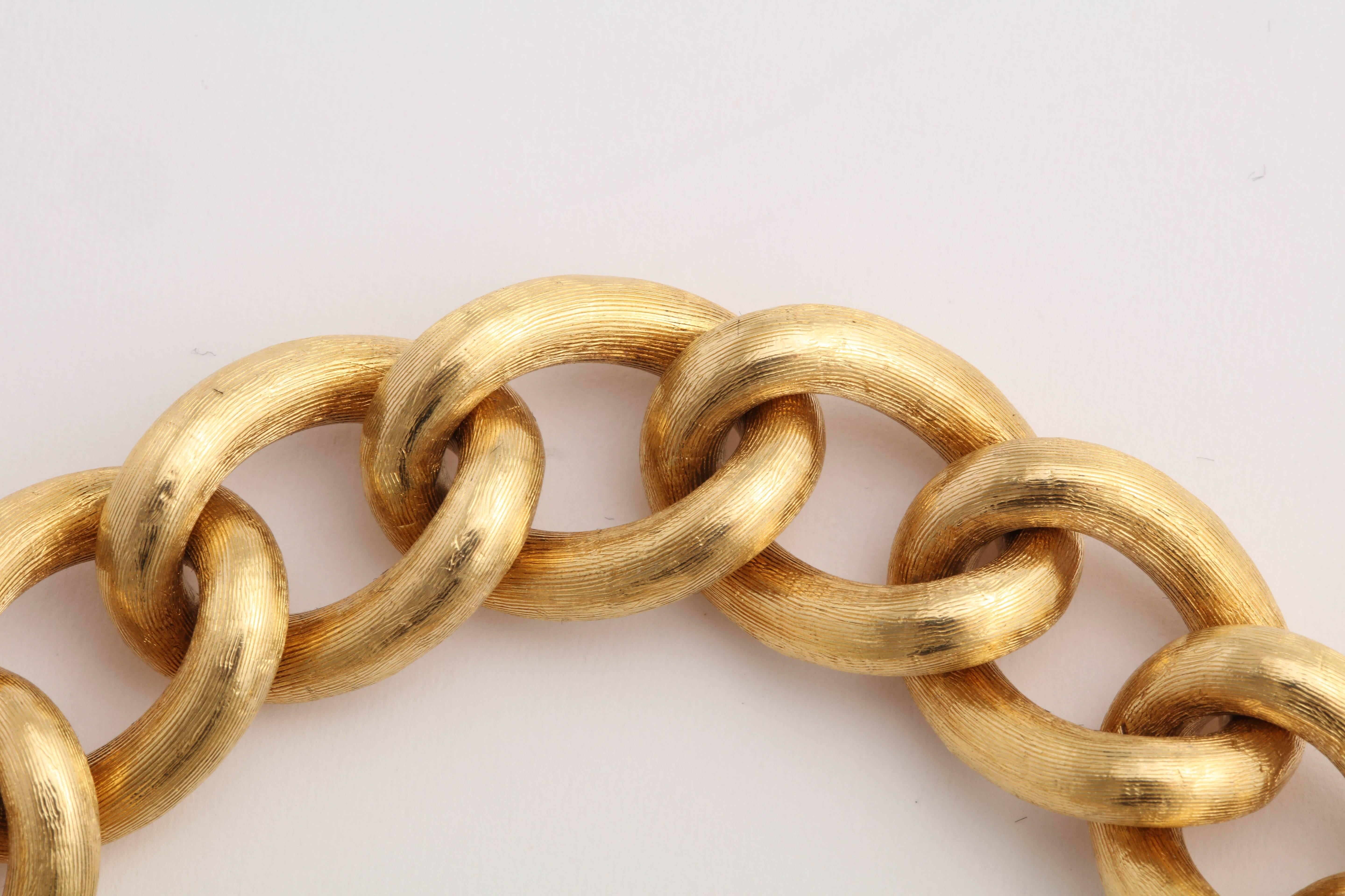 18ky Yellow Gold Cable Link bracelet with box clasp and heavy safety chain. Brushed Florentine finish.  Beautifully made and oh so chic!  How could you live without one!  If you already have one - make that two!