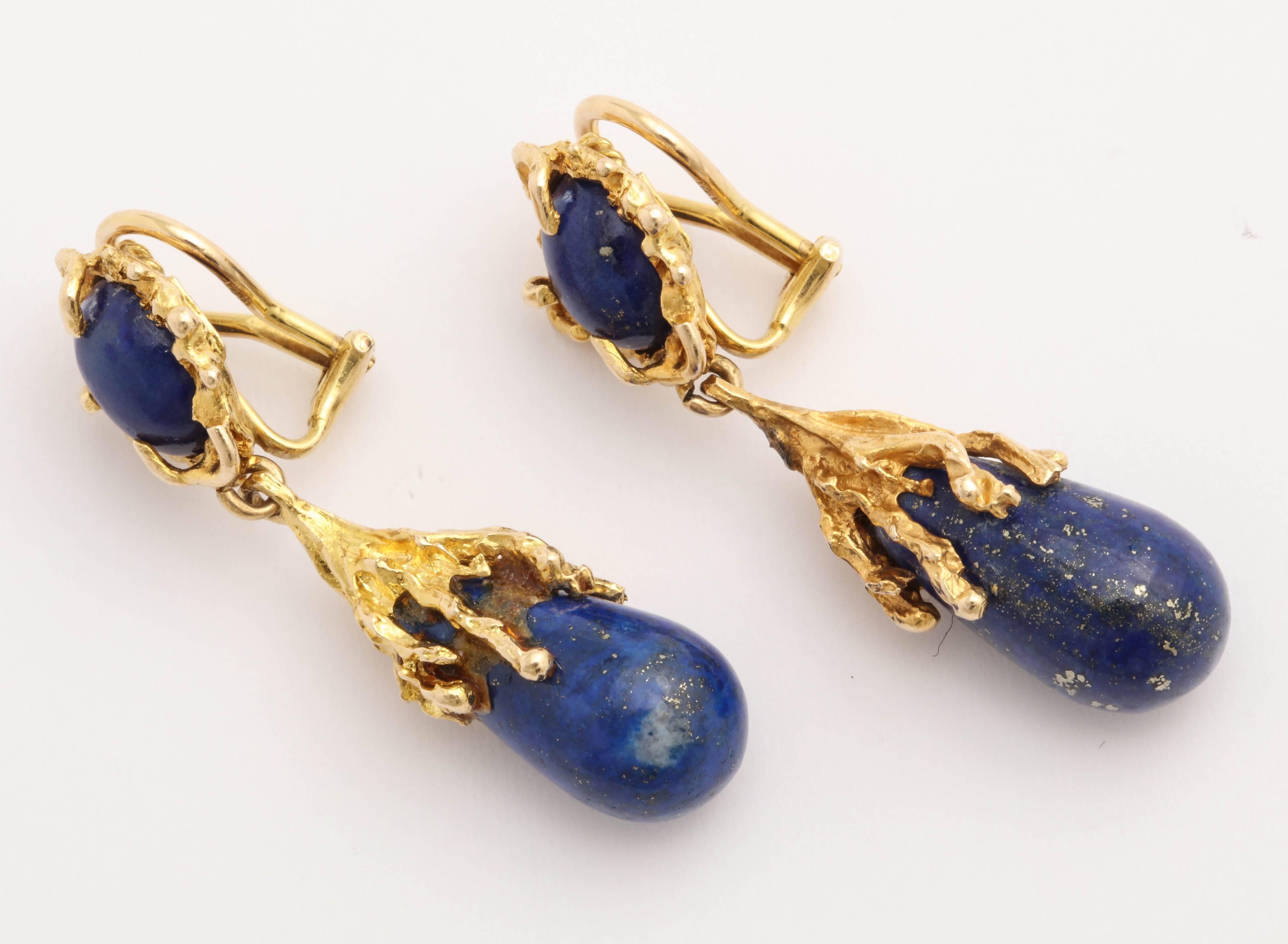Pair of 14kt Yellow Gold Pendant Earrings with Omega Backs.  Can easily be converted to posts. A great look.
Tops are set with cabochon Lapis ovals  in twisted organic twig-like shapes. Pendants are polished ovoid drops.  Very rich and  super cool. 