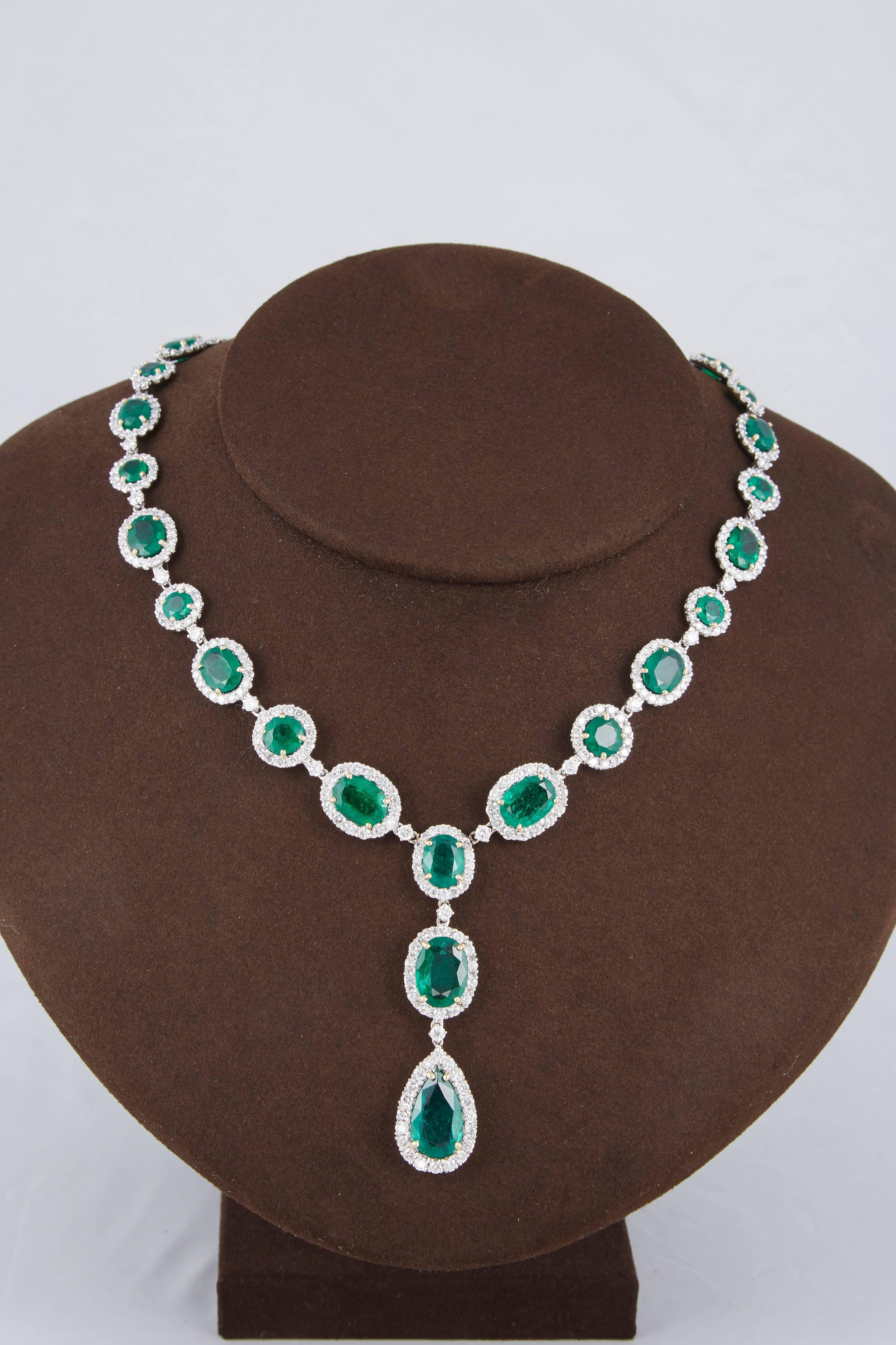 

A beautiful green emerald and diamond necklace in a timeless design. 

38.02 carats of oval and round shaped Fine Green Emeralds with a pear shaped drop. 

12.28 carats of white round brilliant cut diamonds 

18k white gold 