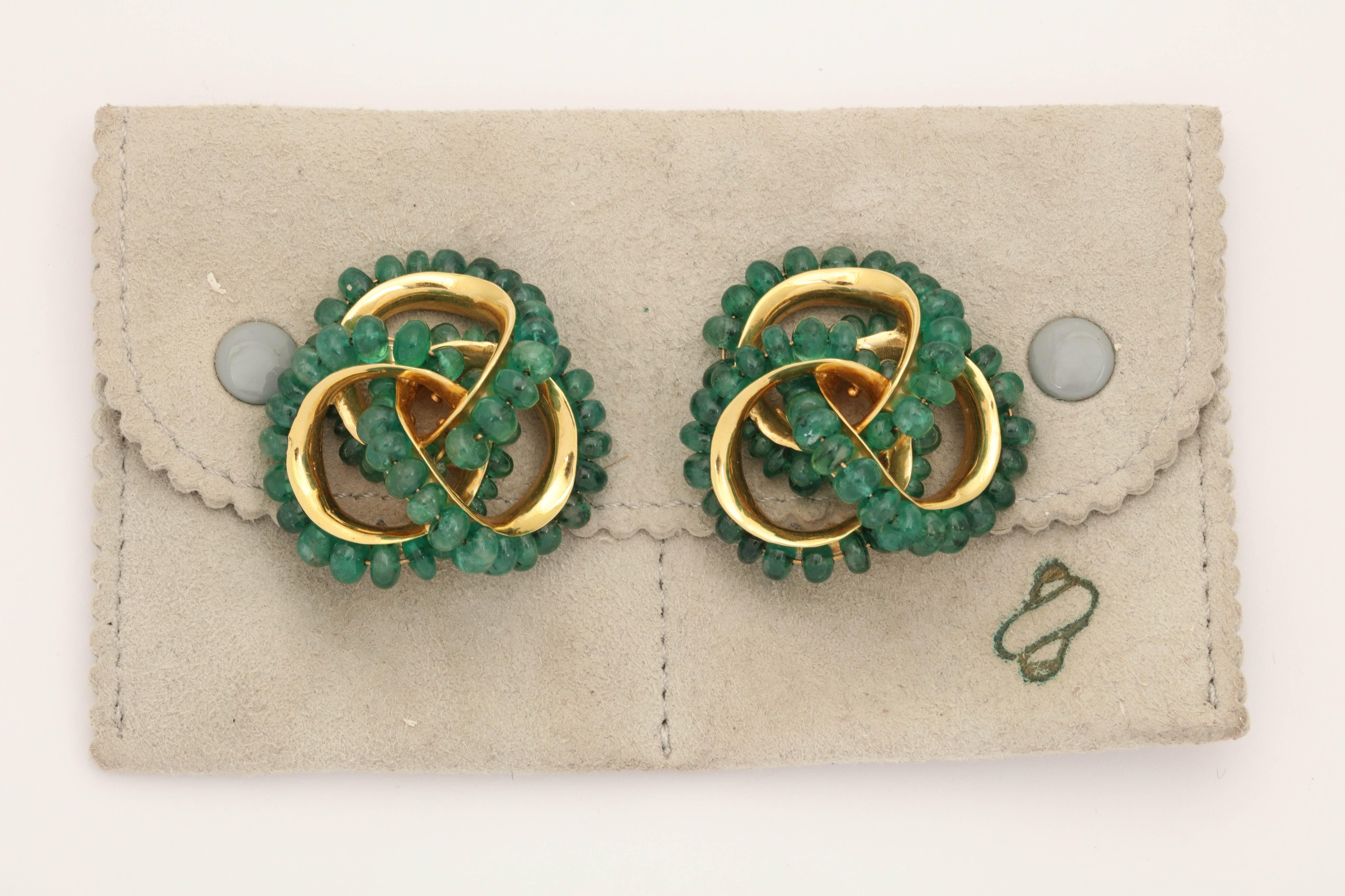 One Pair Of Seaman Schepps 18kt Yellow Gold Earrings Embellished With Numerous Cabochon Emerald Beads Weighing Approximately 15 Carats Total Weight. All Emeralds Set In A Beautiful And Unique Pretzel Knot Twist Design..Note: Posts May Be Added For