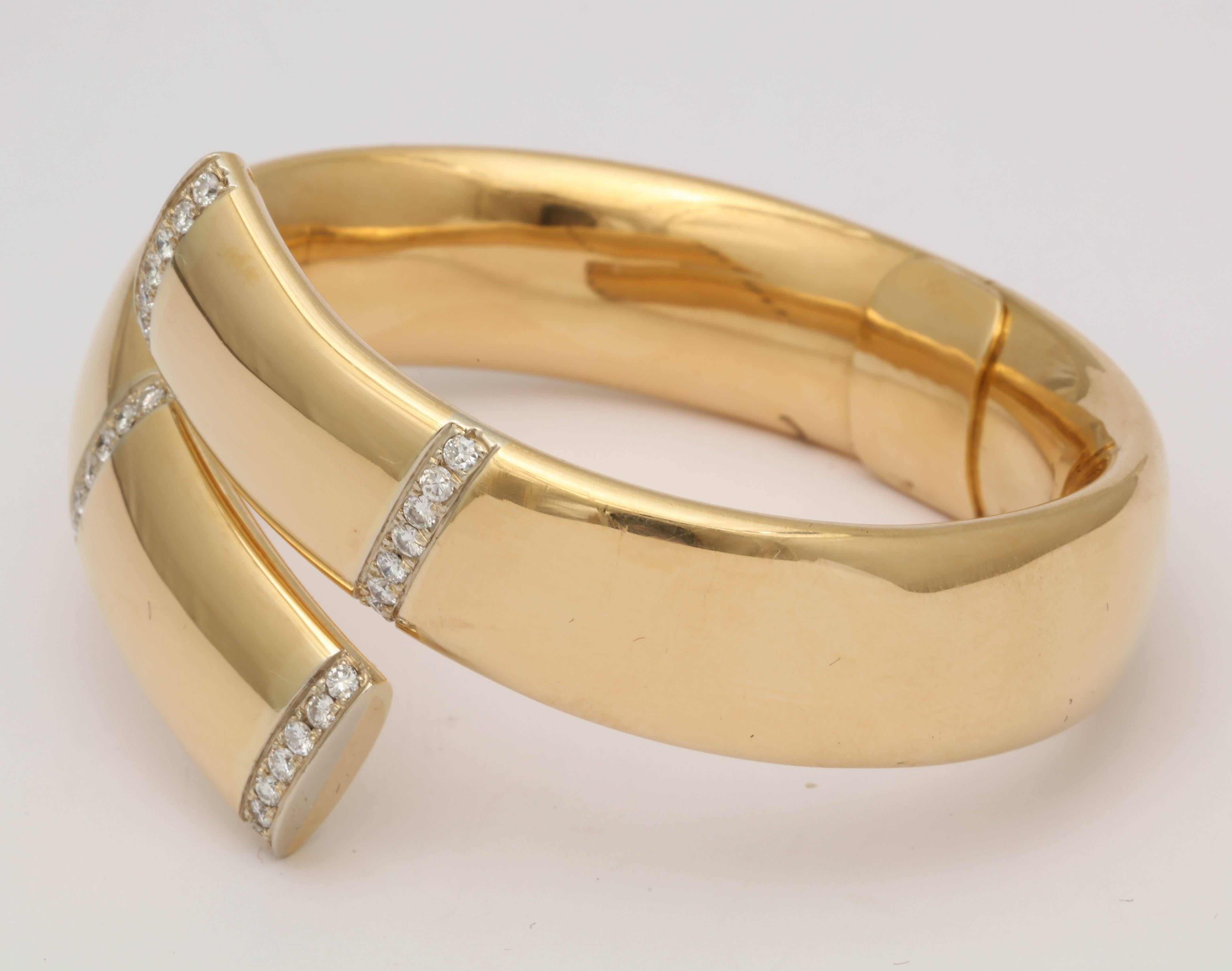 One Ladies 18kt Yellow Gold High Polish Wrap Around Bangle Bracelet Embellished With 32 High Quality Full Cut Diamonds Weighing Approximately 1.50 Carats Total Weight. Beautiful Open Hinged Mechnanism For Easy wear And Very Smooth Finish For A