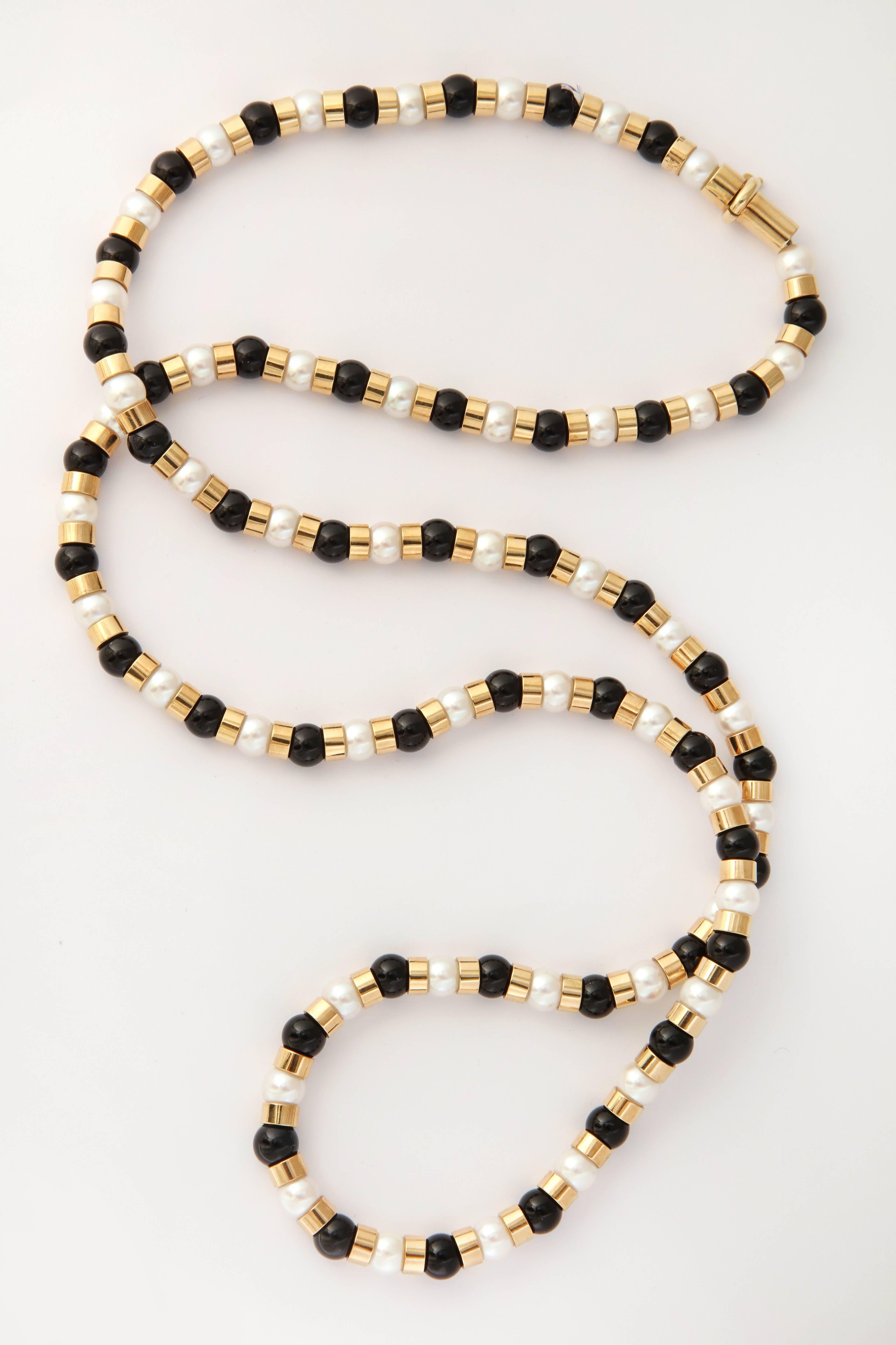 One Ladies Alternating Onyx Ball And Cultured Pearl Necklace Designed By Chanel Paris In The 1990's. Each Onyx And Pearl Measuring Approximately 7 Mm Each .47 onyxes In Total And 48 White Cultured Pearls In Total. Necklace Further Embellished With