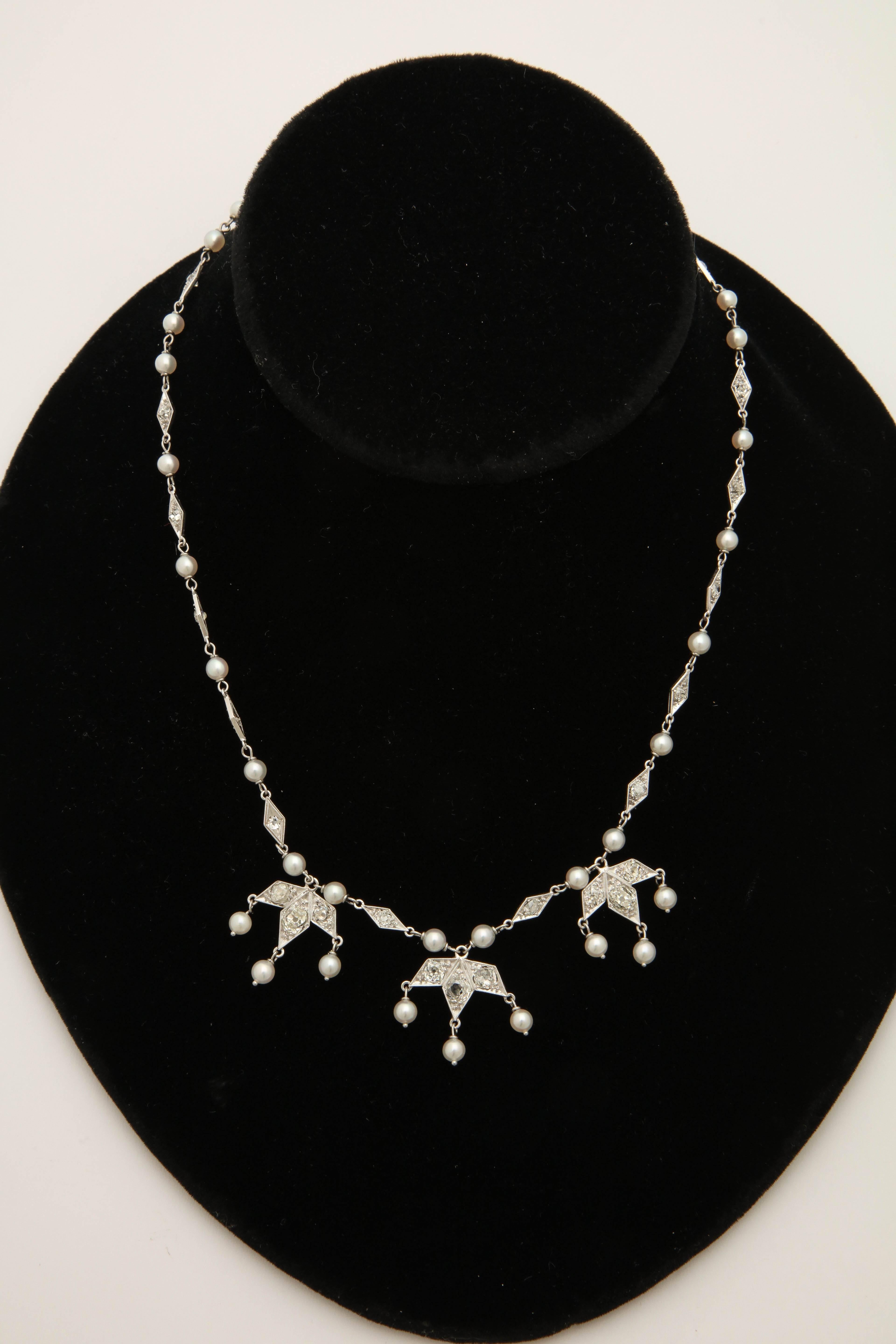 One Ladies Delicate Platinum Necklace Embellished With Numerous Antique Cut Diamonds Weighing Approximately 4 Carats Total Weight. Further Designed With Thirty Seven 3 mm Seed Pearls. Beautiful And Unusual Triple Pendant Design In Front Of Necklace