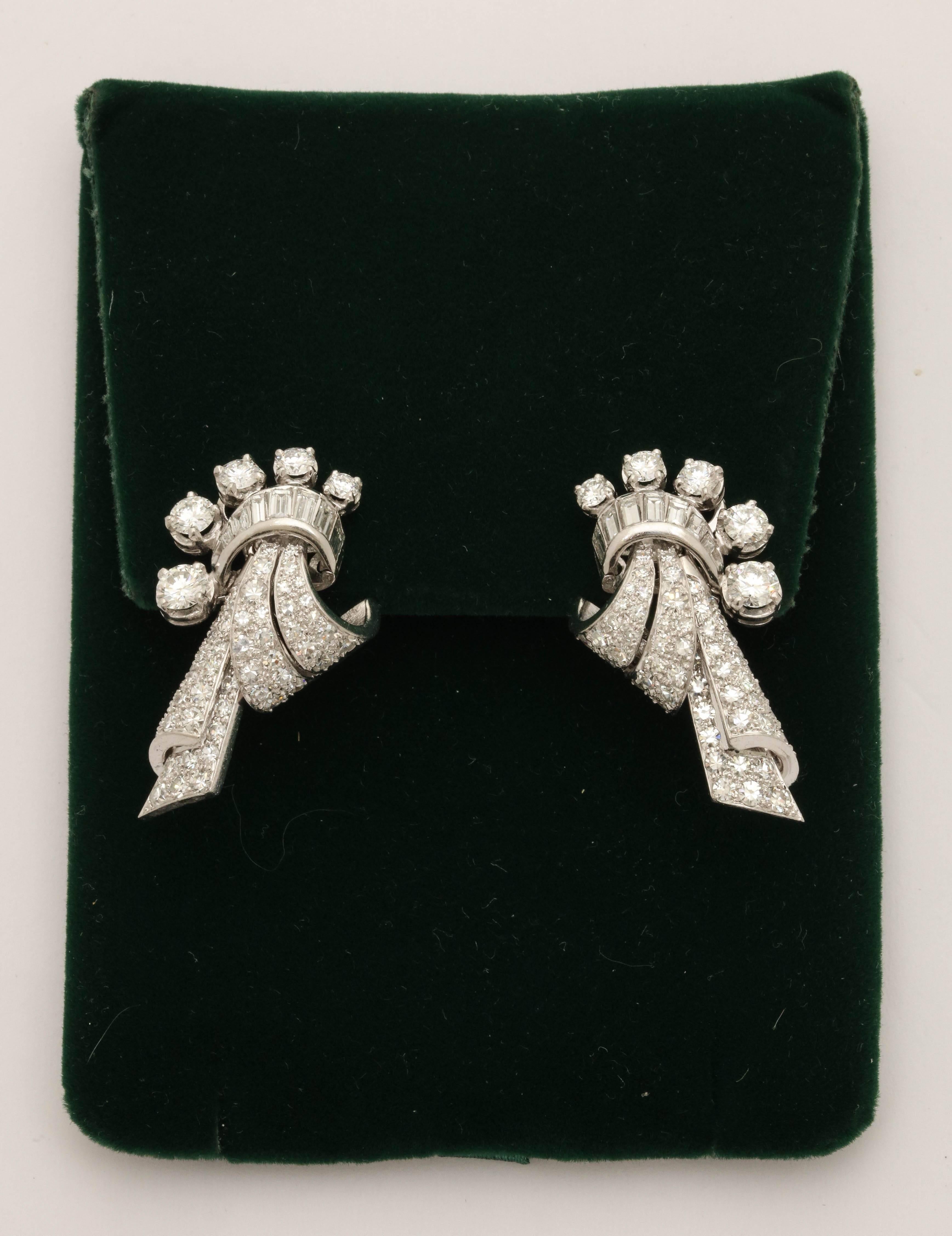 One Pair Of Ladies Clip On Earrings In Form Of A Drape Design Embellished With Numerous Round Cut Diamonds Weighing approximately 3 .75 Carats. Further Encrusted With Numerous High quality Baguette Cut Diamonds Weighing Approximately 1.50 Cts. Total