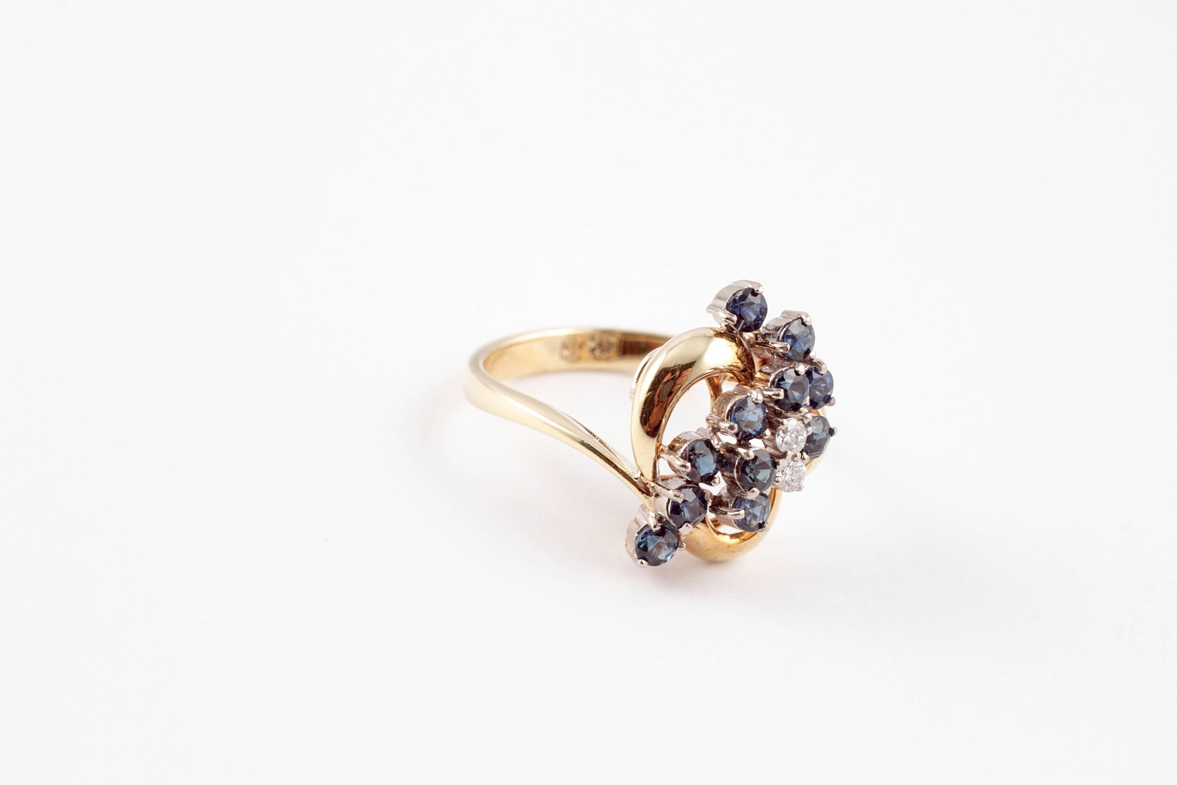 Blue sapphires dancing with diamond accents in a 14 karat yellow gold mounting.  Size 6 3/4.