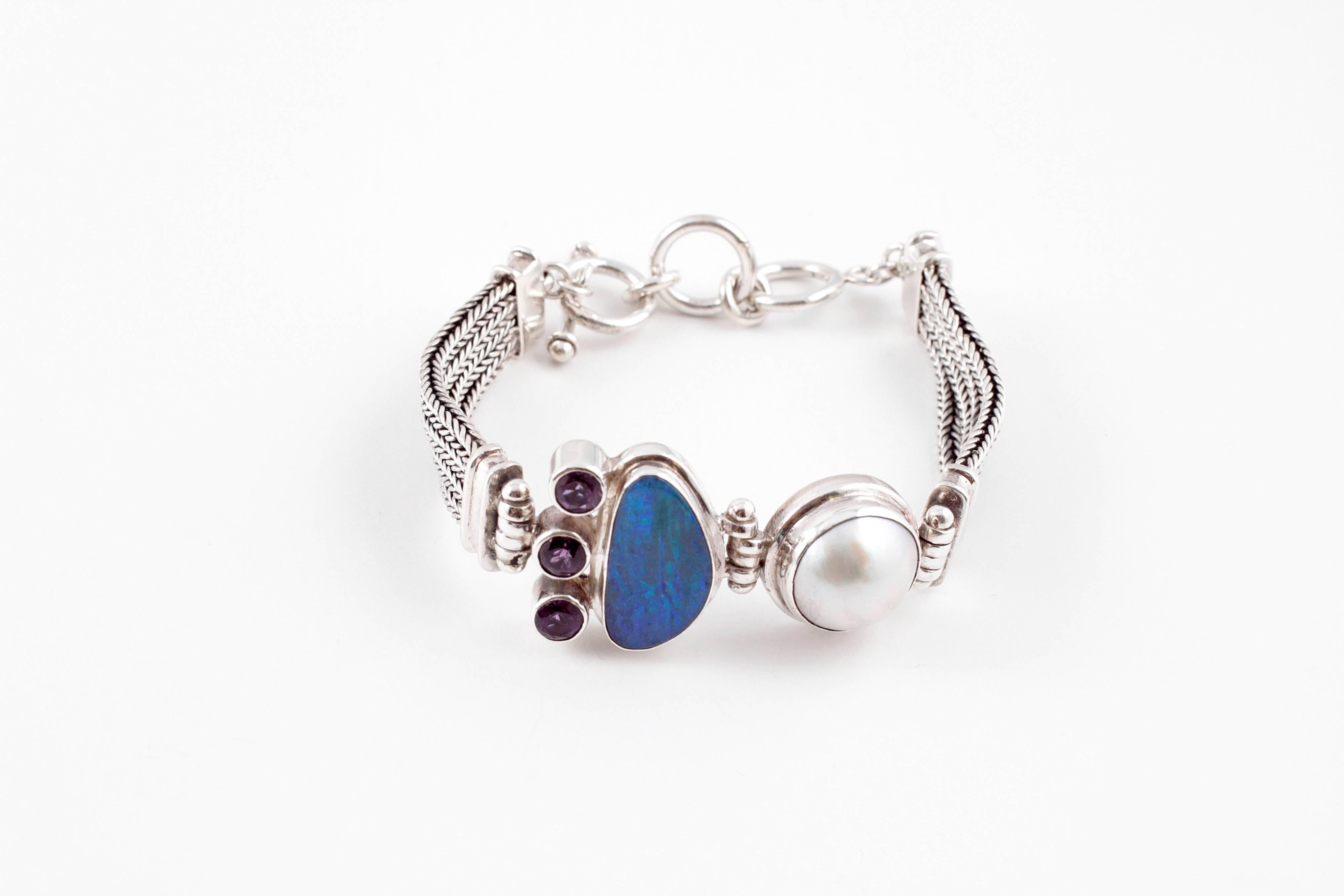Delightful Sterling Silver bracelet featuring opal, amethyst, and mabe pearl.  8 inches.