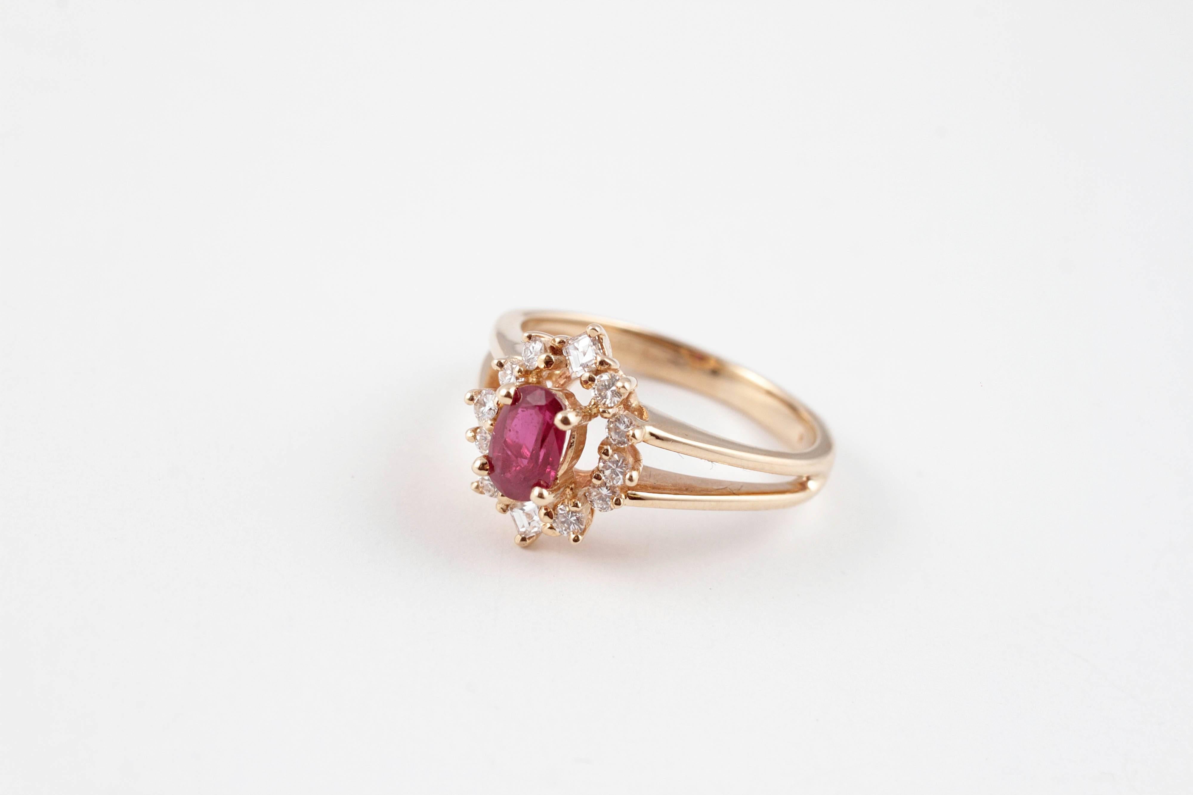 Lovely .65 carat ruby surrounded by .30 carats of diamonds on split 14 karat Gold mounting.  Size 5.5.