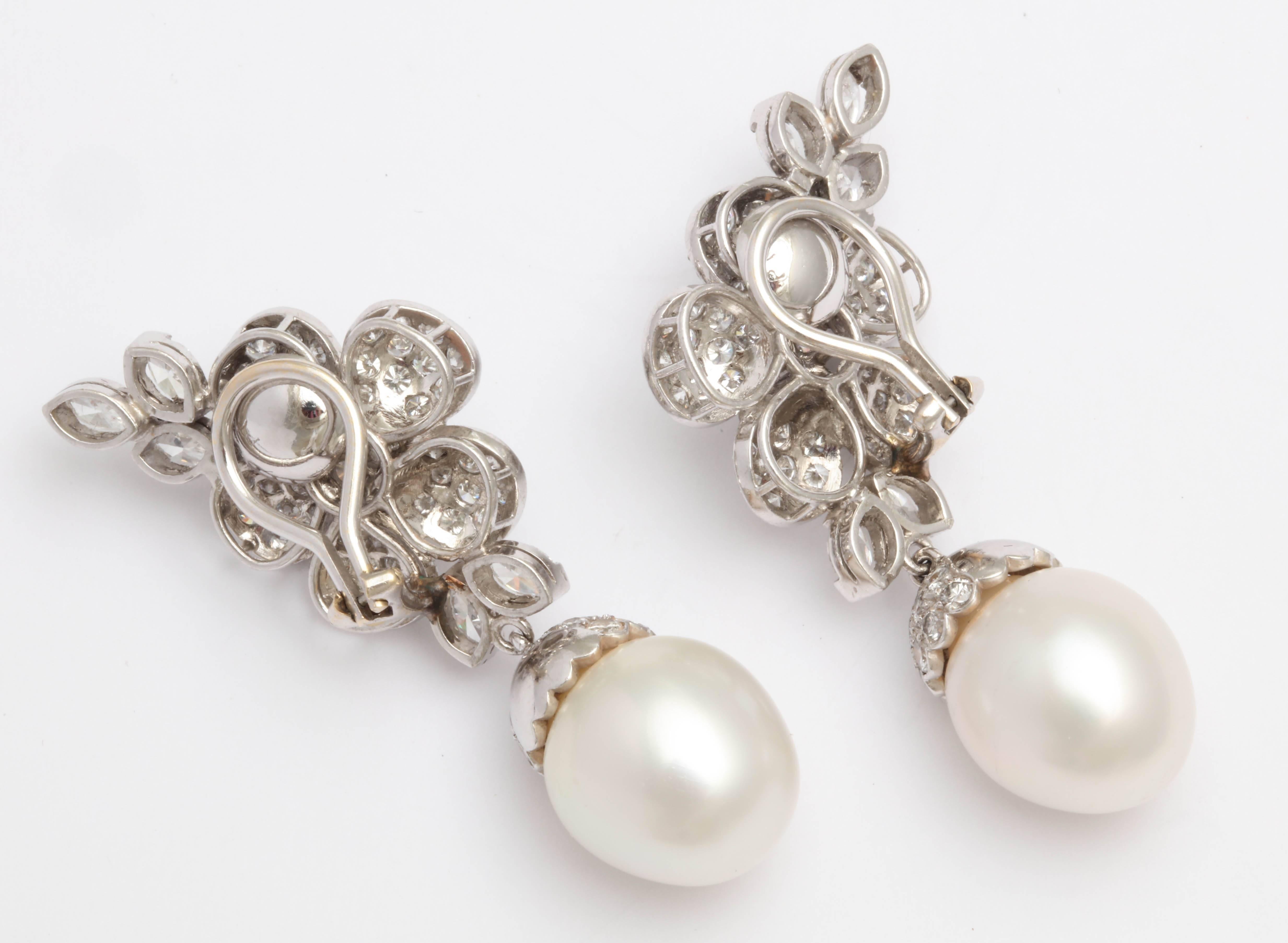 Great pair of Diamond capped  South Sea Pearl & Floral  Diamond Earrings.
Very chic & ultra sexy.  A very sophisticated look
Tops are a central 5 petal flower with a central Diamond Rosette and Diamond Leaves to accentuate the length & soften the