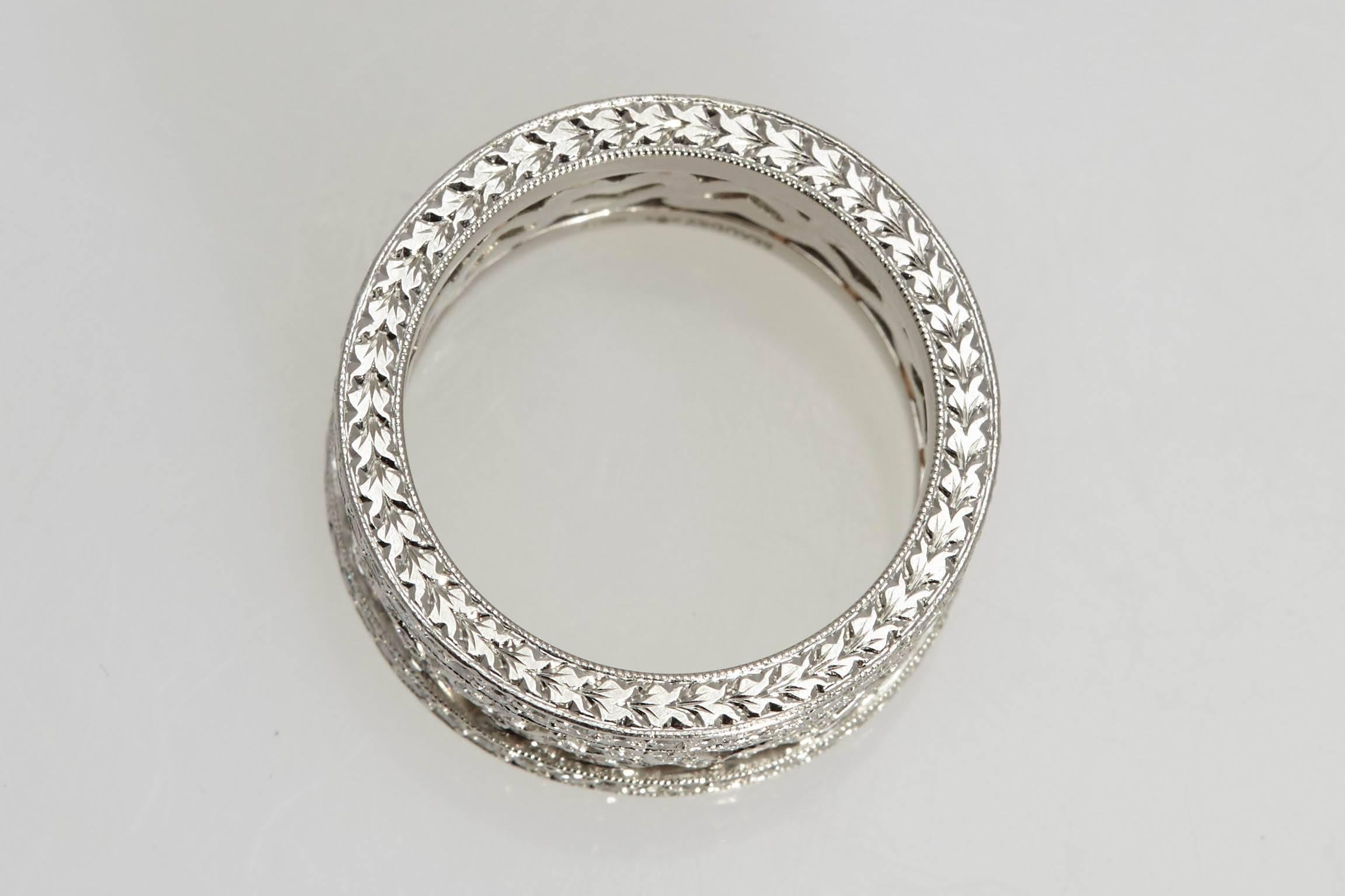 Beautifully designed platinum and diamond eternity ring with diamond hearts in an alternating pattern in the center and a band of diamonds on the outside of the hearts pattern.  The ring contains approximately 1.20 carats in diamonds. The ring is