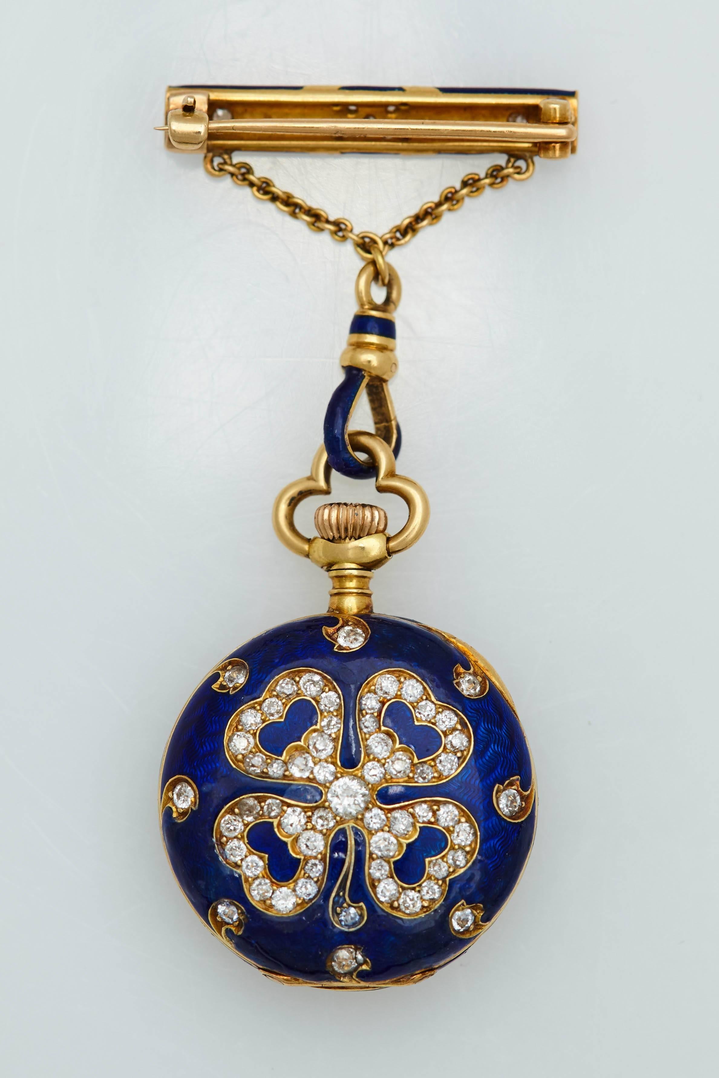 A beautiful ladies Victorian style Shamrock blue enamel, eighteen karat yellow gold and diamond brooch.  On one side of the blue enameled brooch is a Shamrock clover leaf pattern set with old mine cut diamonds and on the reverse side of the brooch