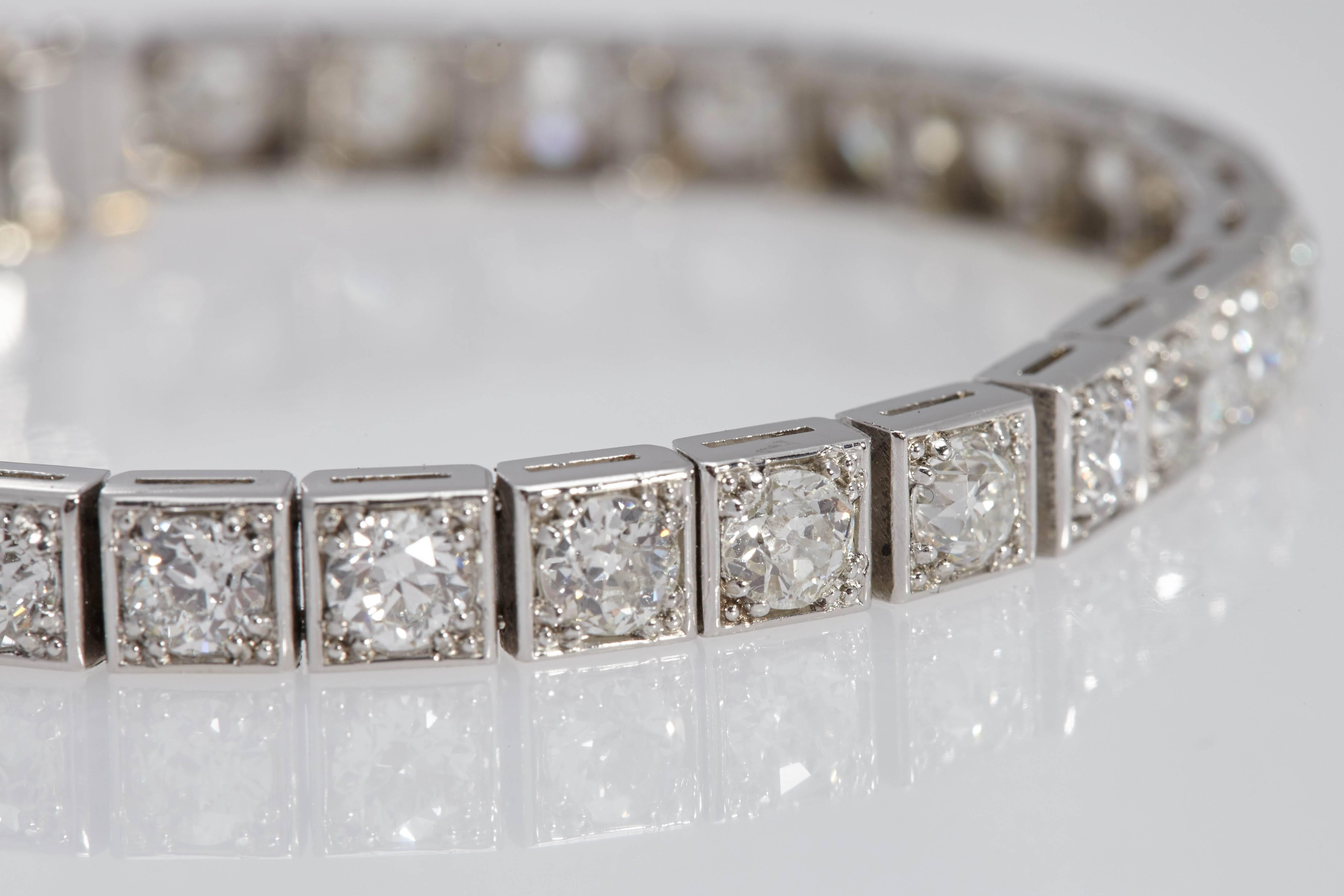 31 old mine cut diamonds weighing approximately 12 carats set in a platinum bracelet measuring 71/2 inches long. The diamonds are G/H in color and VS in clarity. Each diamond is set in an individual square box, in an art deco style. 