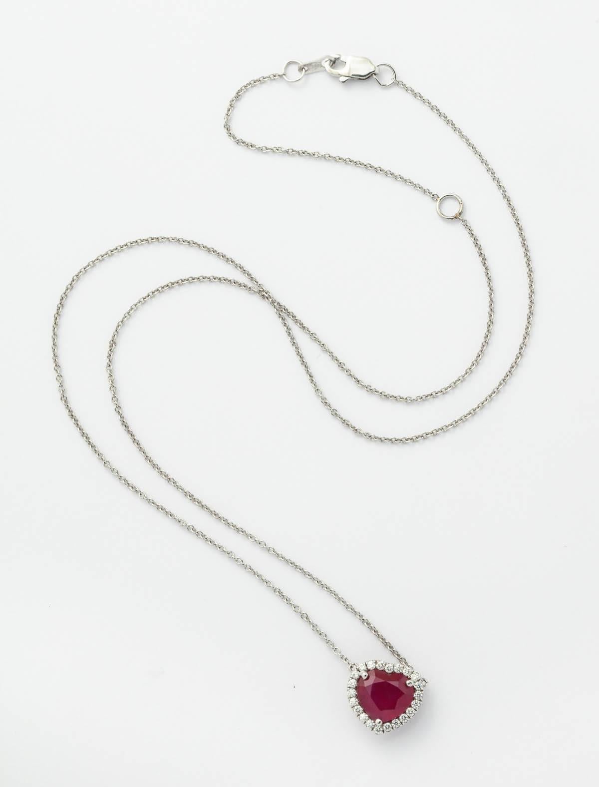 18k white gold heart shape Burmese ruby and diamond necklace 
Center Burmese ruby 2.12 ct. surrounded by 22 full cut round diamonds weighing 0.15 ct. total weight
18k, 18" adjustable cable link chain

AGL report #CS36208
