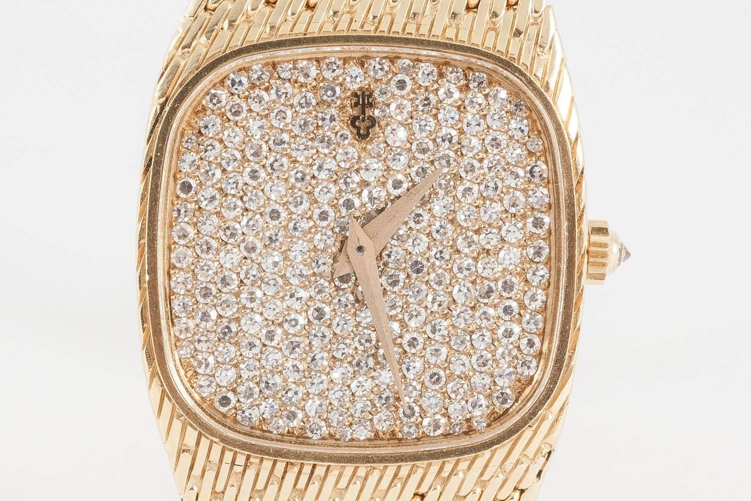 An 18ct yellow gold ladies wristwatch by Corum with a mechanical,diamond set jewelled movement,c,1960, marked on dial and bracelet.7and a quarter inches [180mm long] dial 20mm